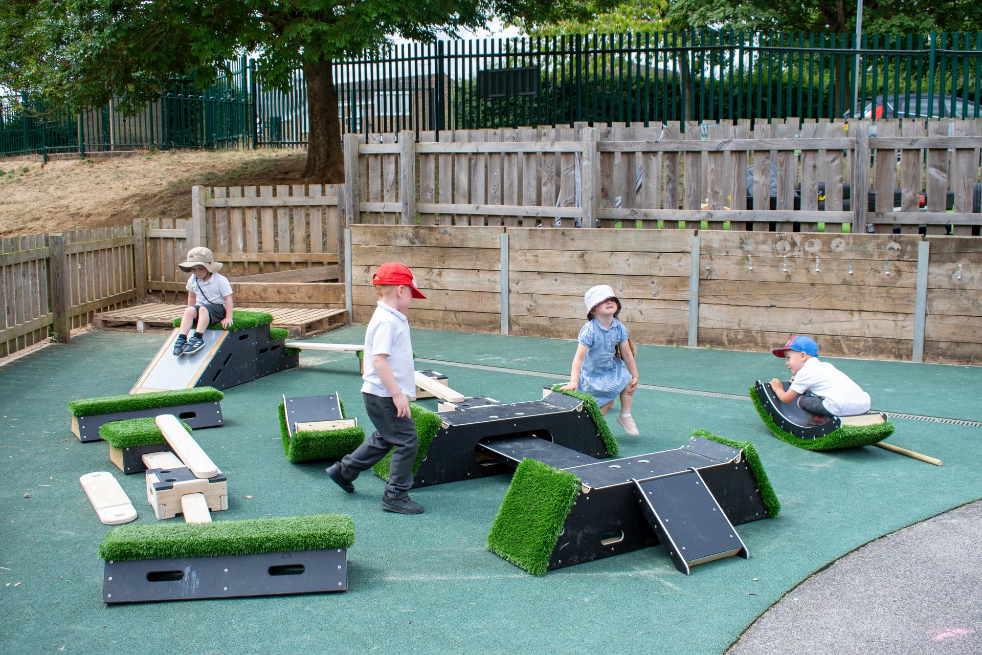 Children climbing balancing and sliding on the different equipment that makes up their active play set