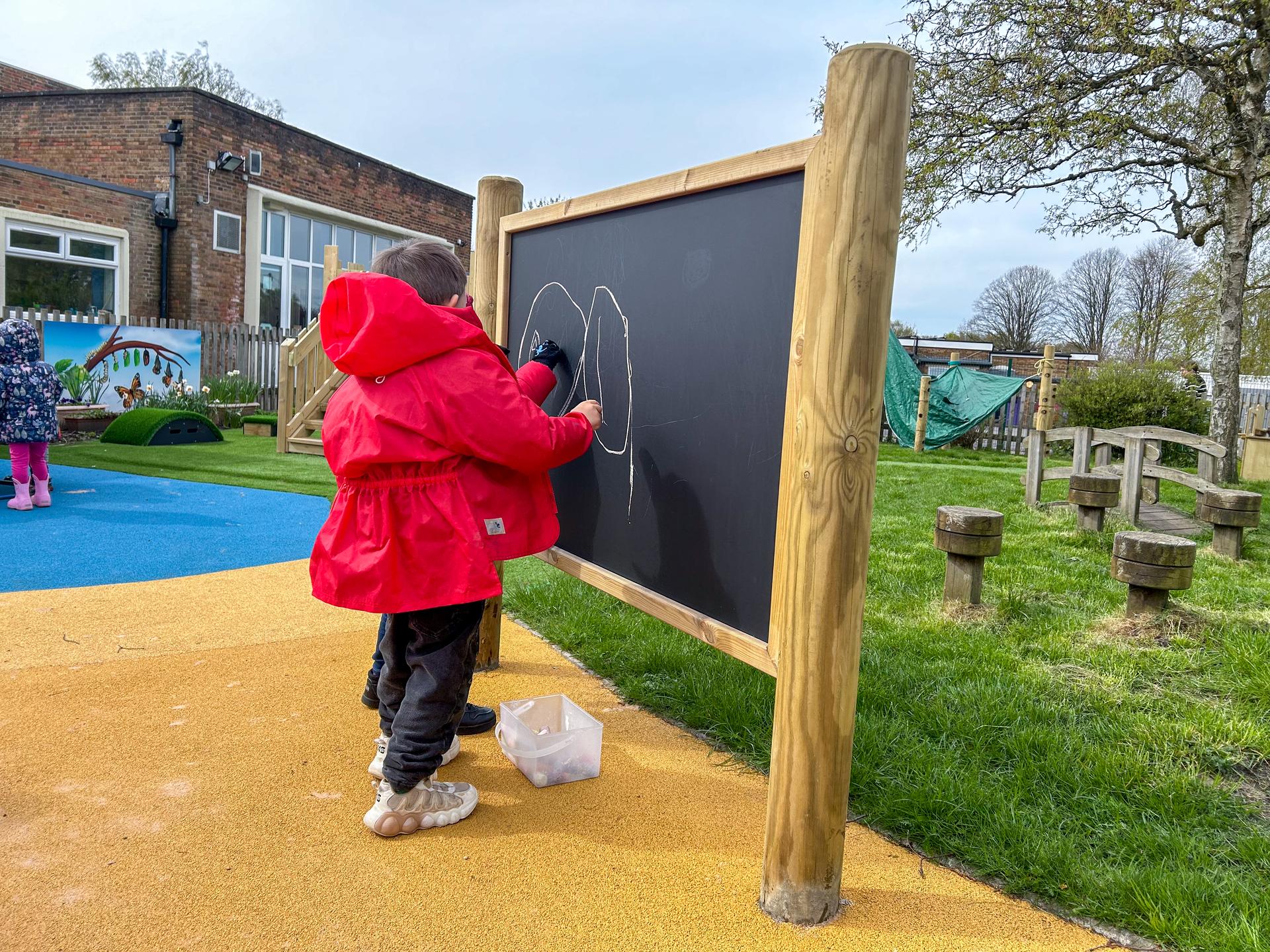 Giant wooden chalkboard on posts from Pentagon Play