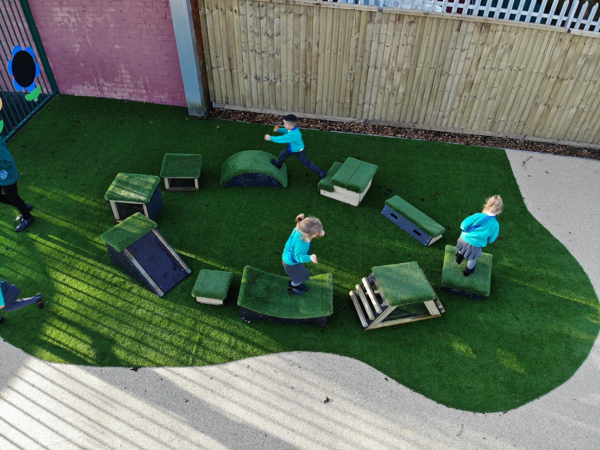 School children playing with grass-topped Get Set, Go! Blocks - The Mendips Set.