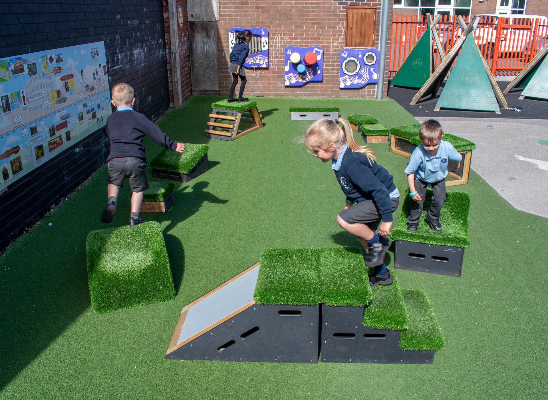 School children playing with grass-topped Get Set, Go! Blocks - The Mendips Set.