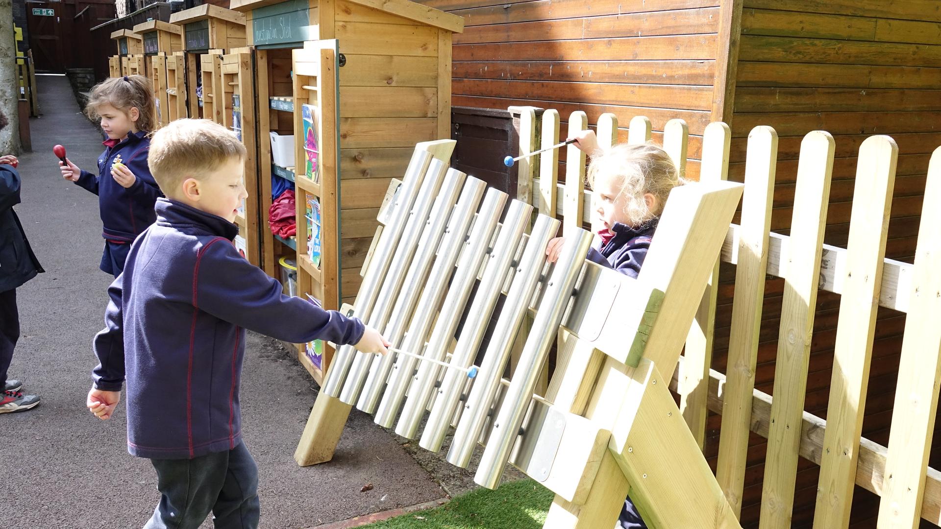 A young boy creating music on the mini freestanding chimes