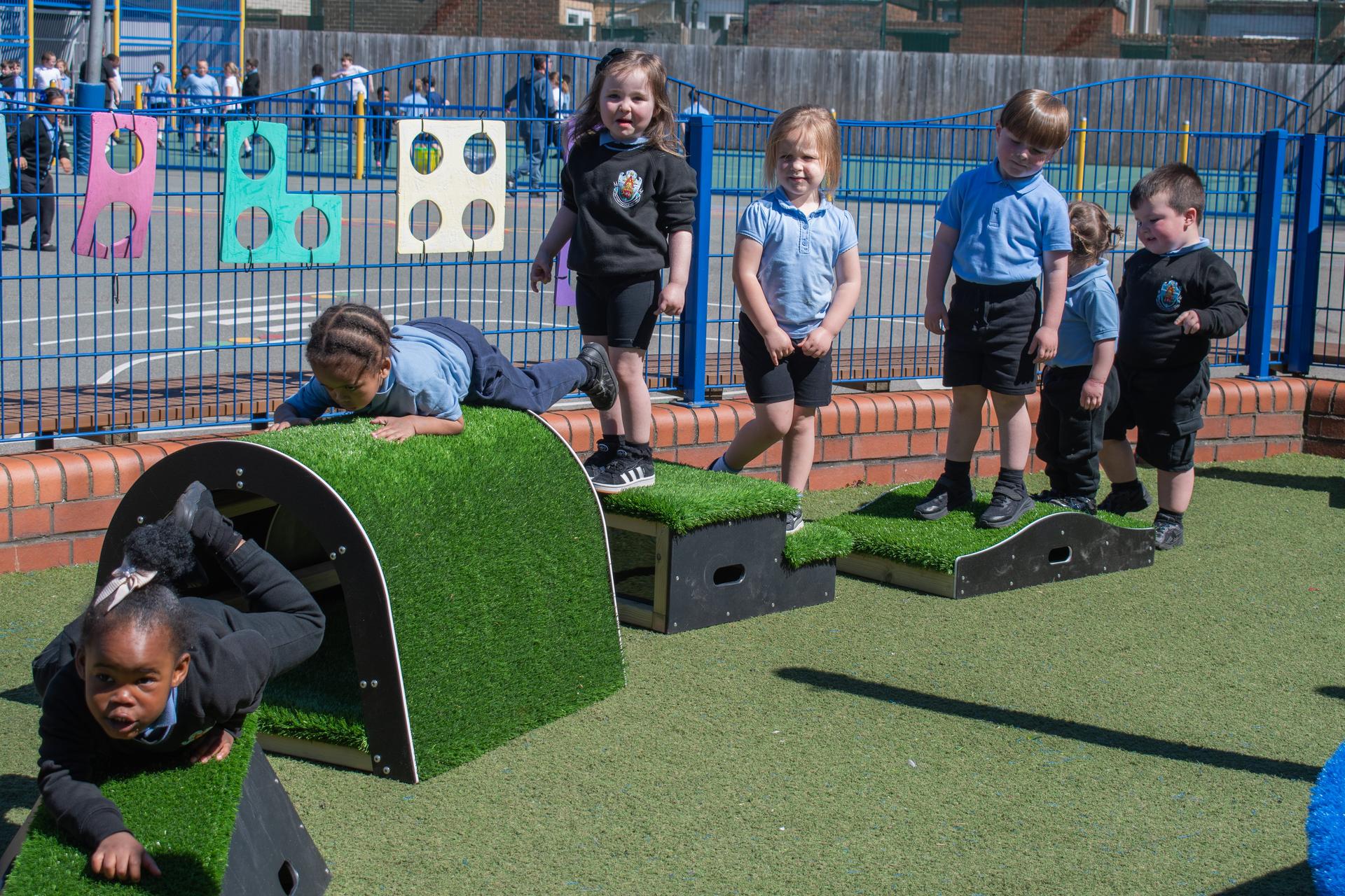 A group of children standing on the blocks featured in the Get Set, Go! Blocks - Next Steps package.