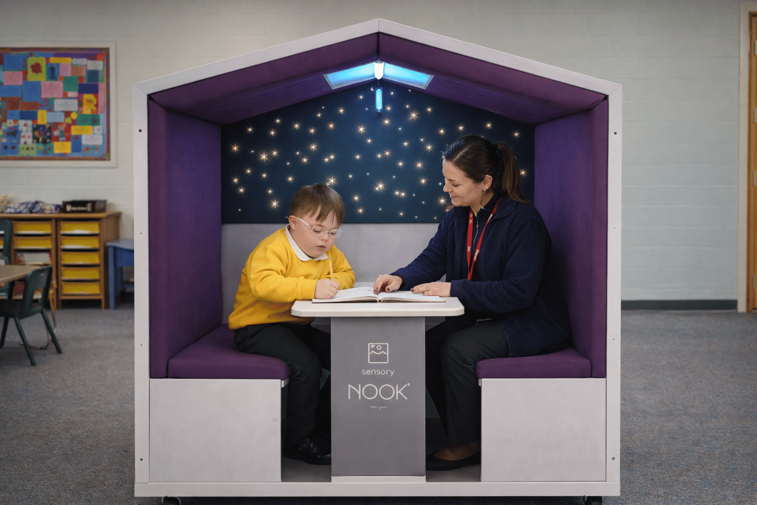 SEN child and teacher are sat within the Sensory Nook Support structure.