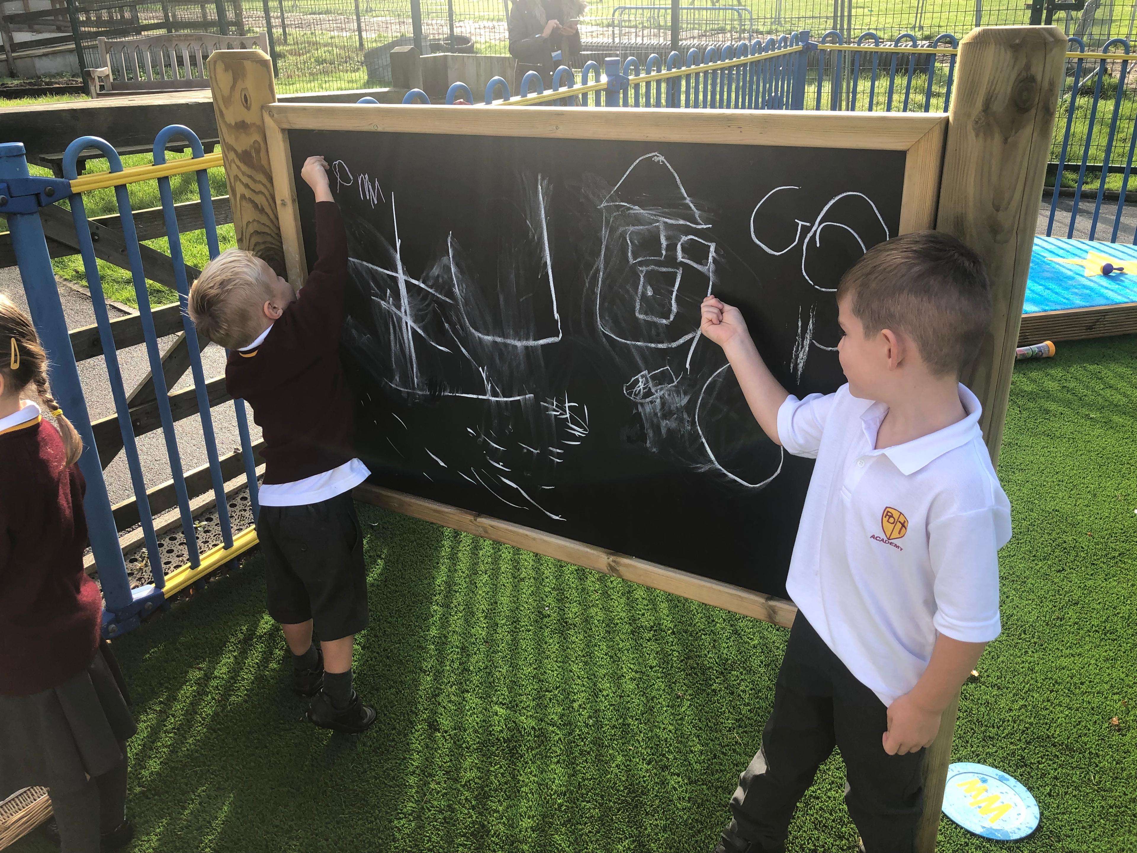 Giant wooden chalkboard on posts from Pentagon Play