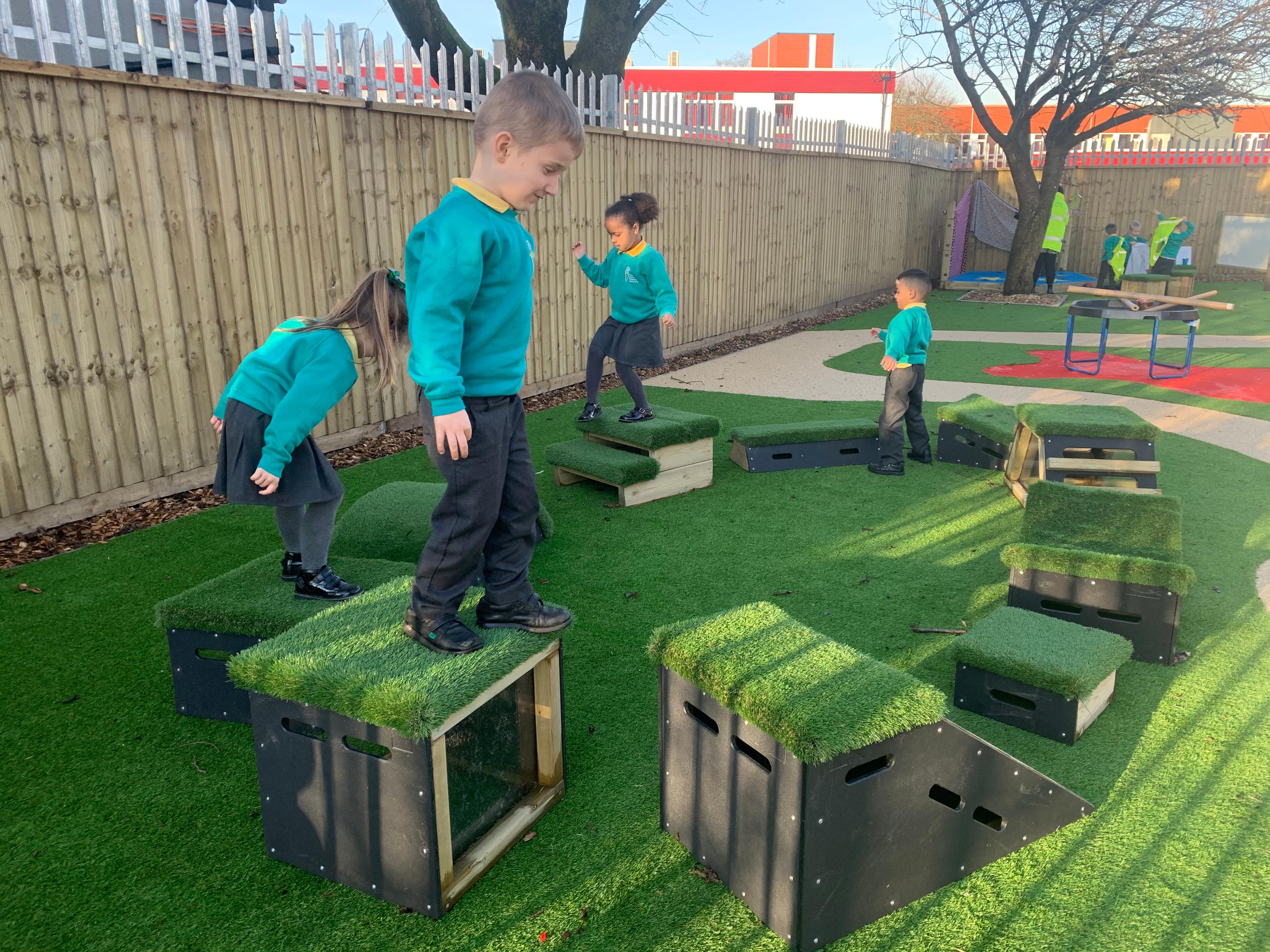 School children playing with grass-topped Get Set, Go! Blocks - The Mendips Set.