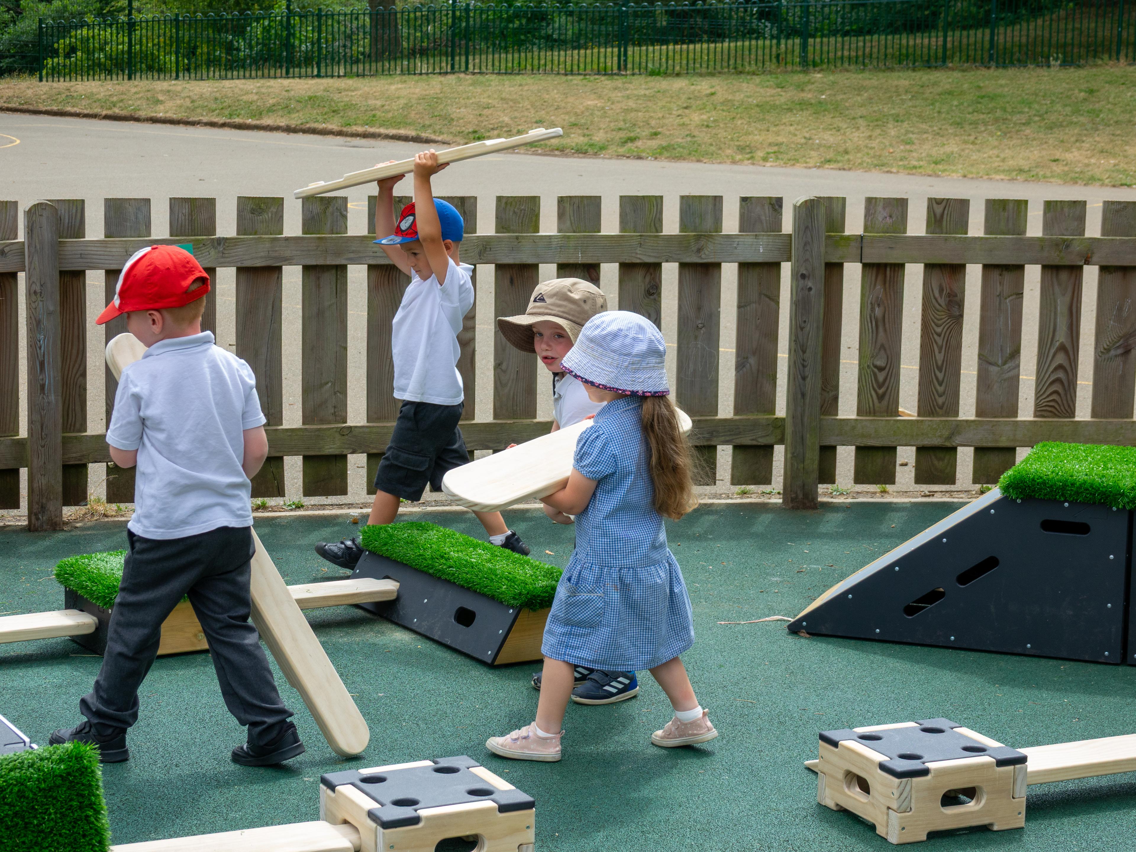 Children carrying Play Builder planks to make their own trail