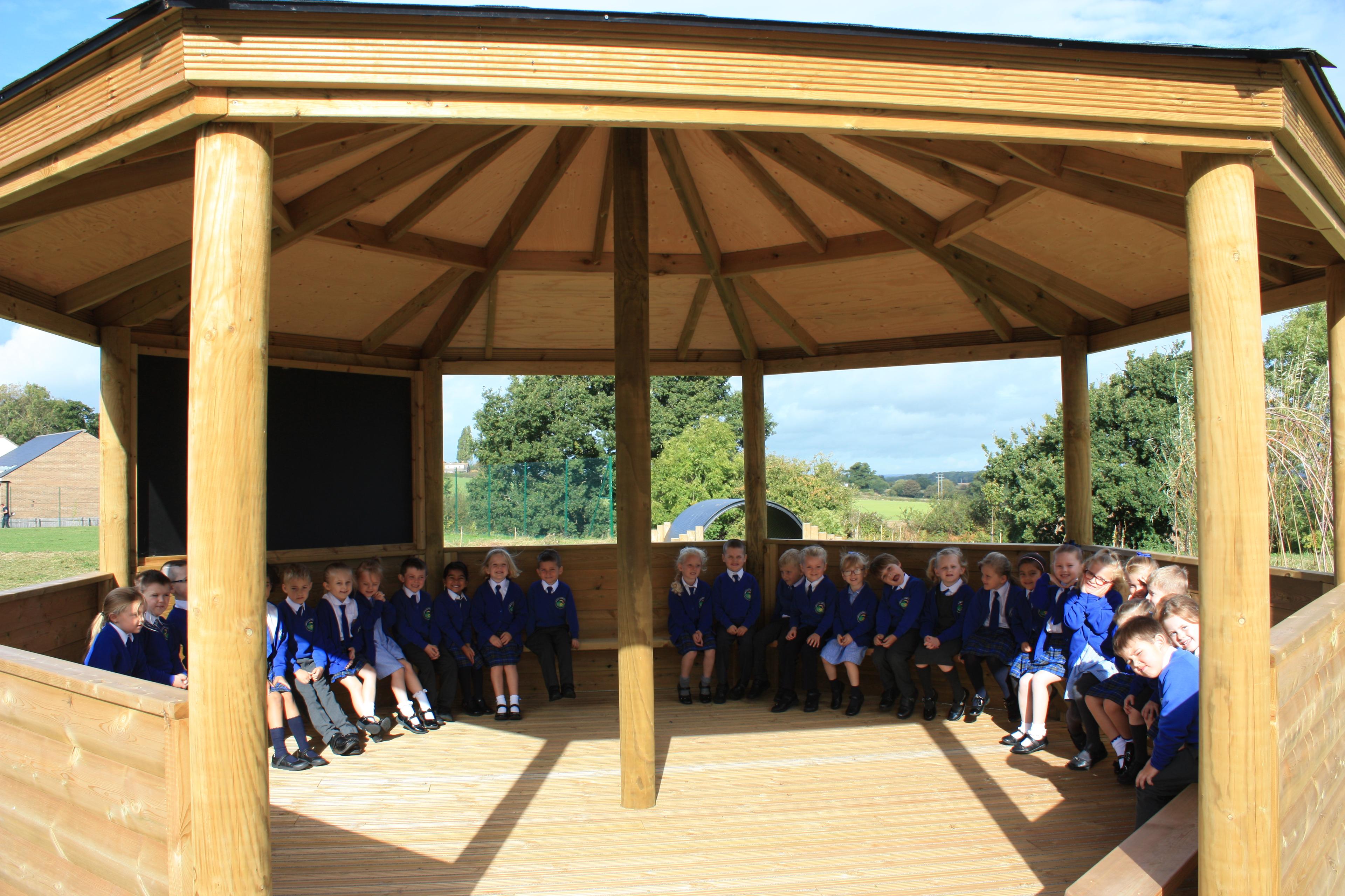 Wooden 6m Octagonal Gazebo with decked base in a school playground.