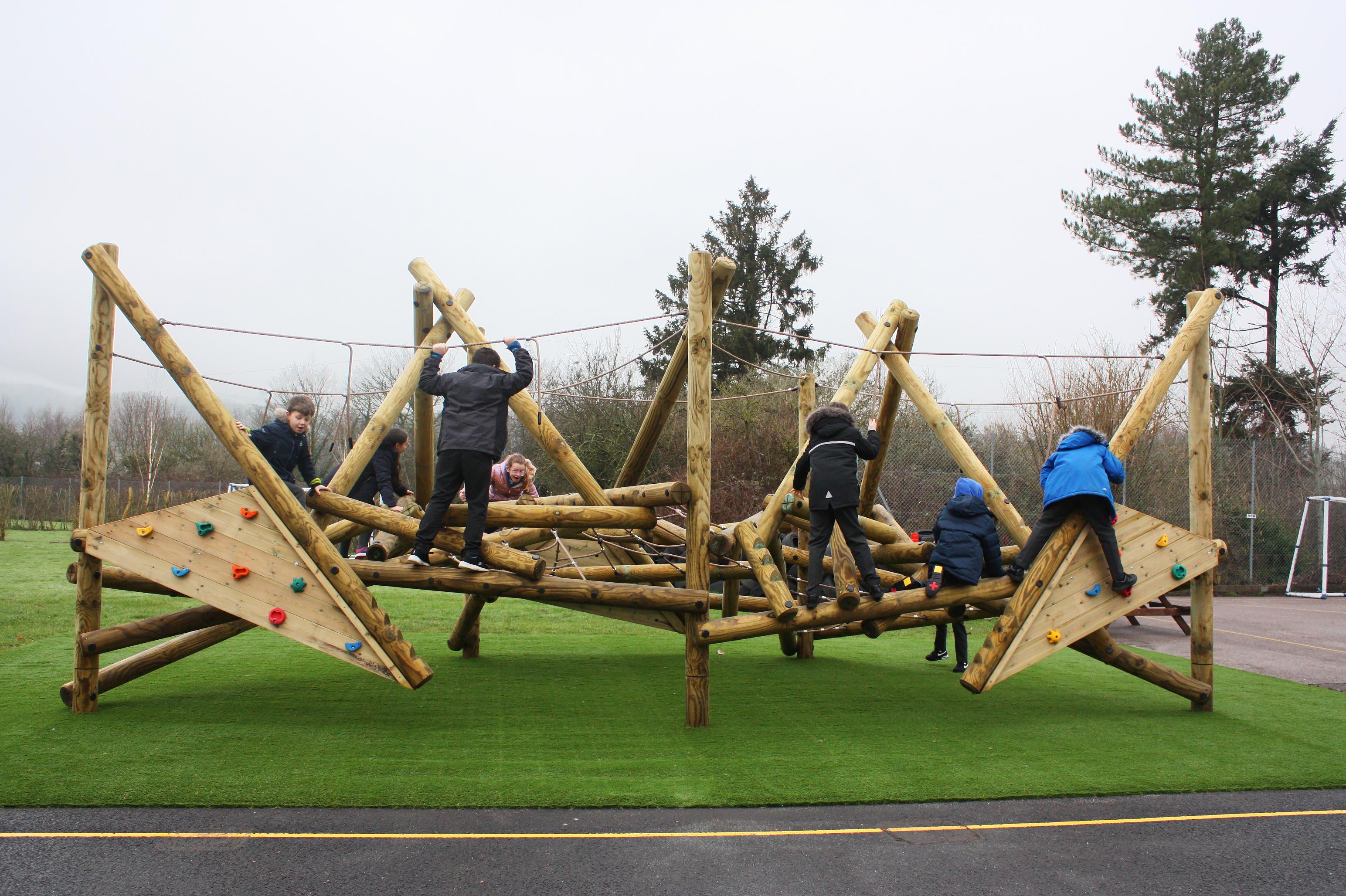 Wooden Crinkle Crags climbing frame in a school playground.