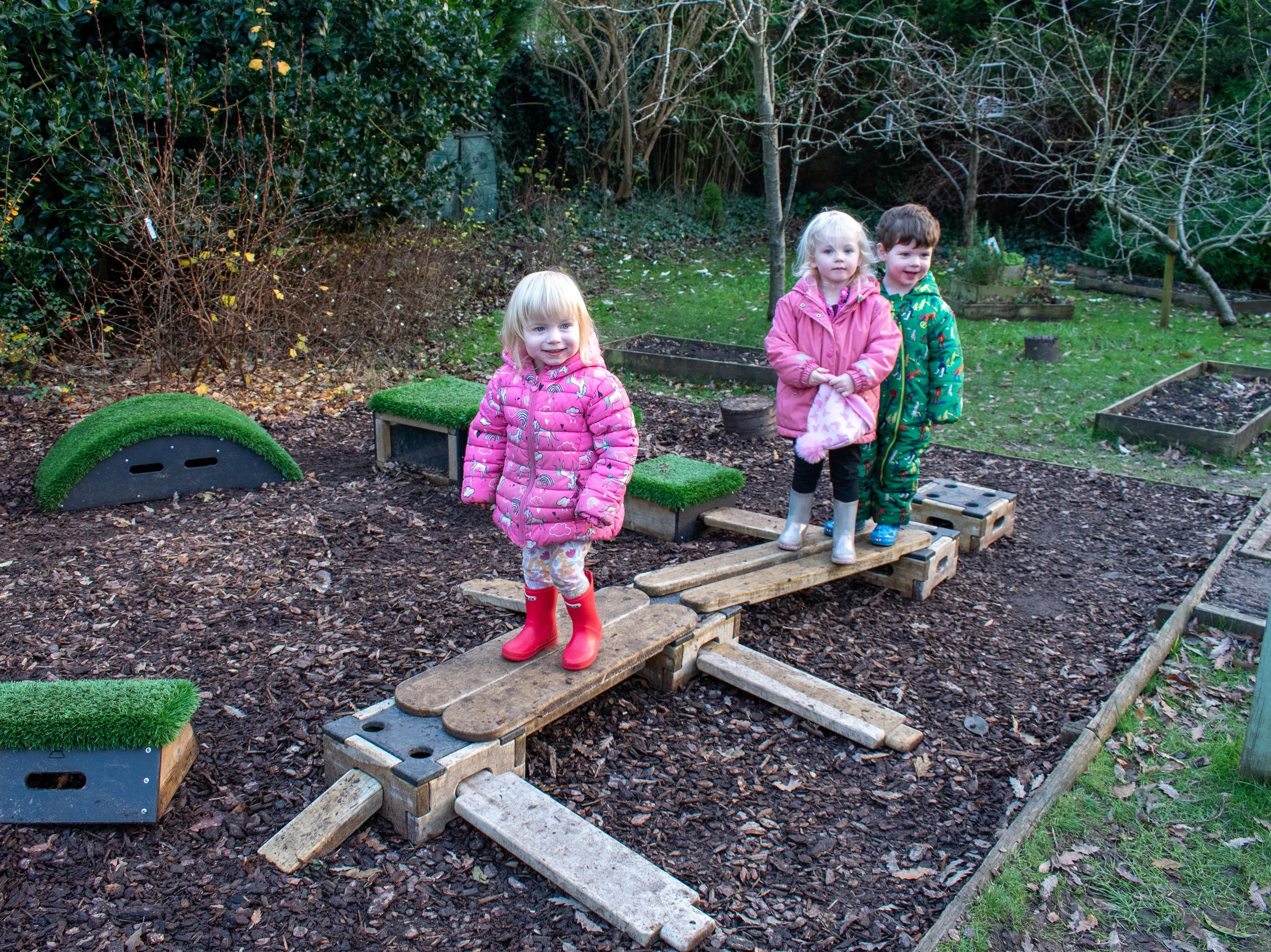Children standing on playbuilder, part of the sports premium adventurer set