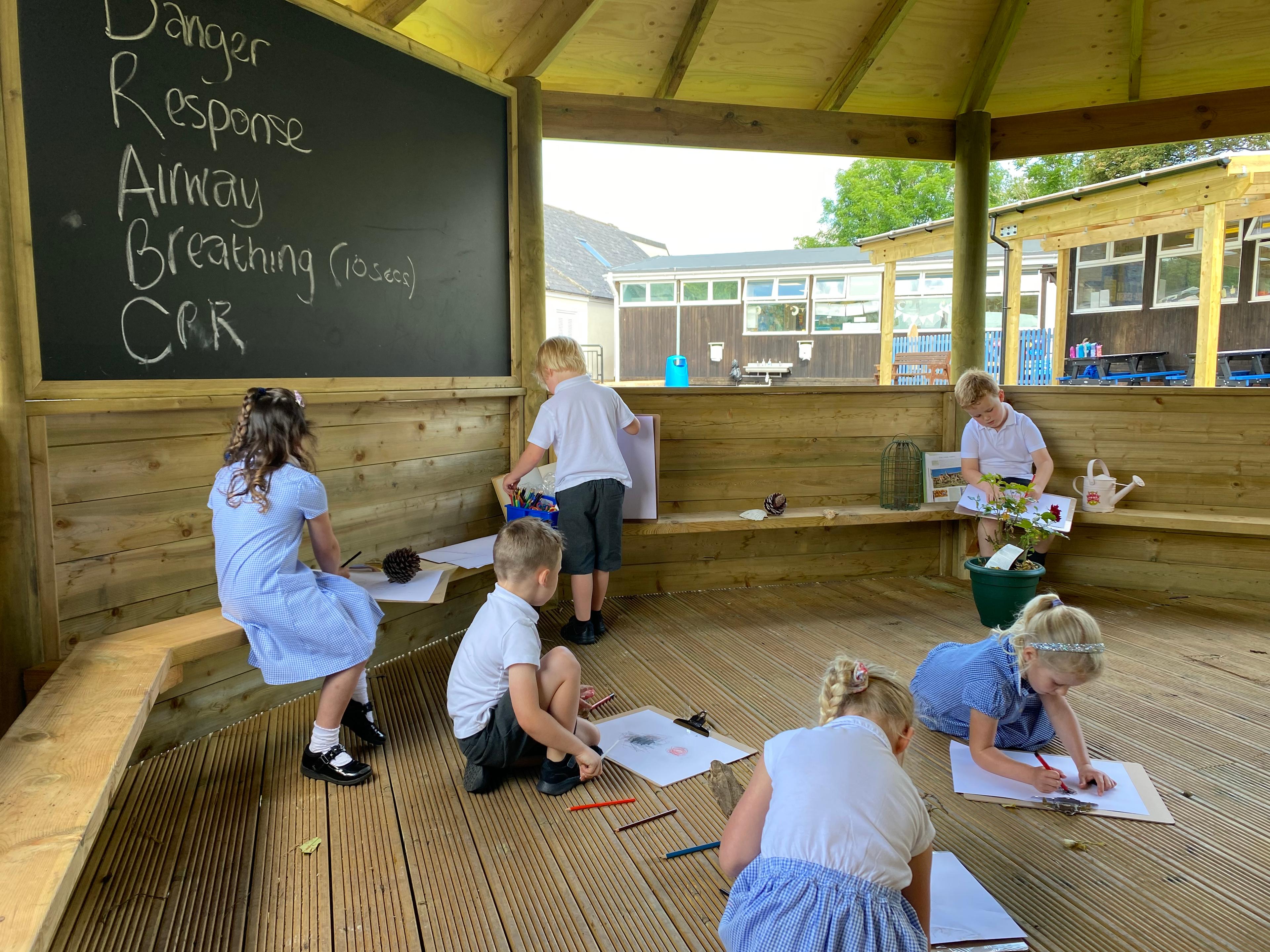 Wooden 6m Octagonal Gazebo with decked base in a school playground.