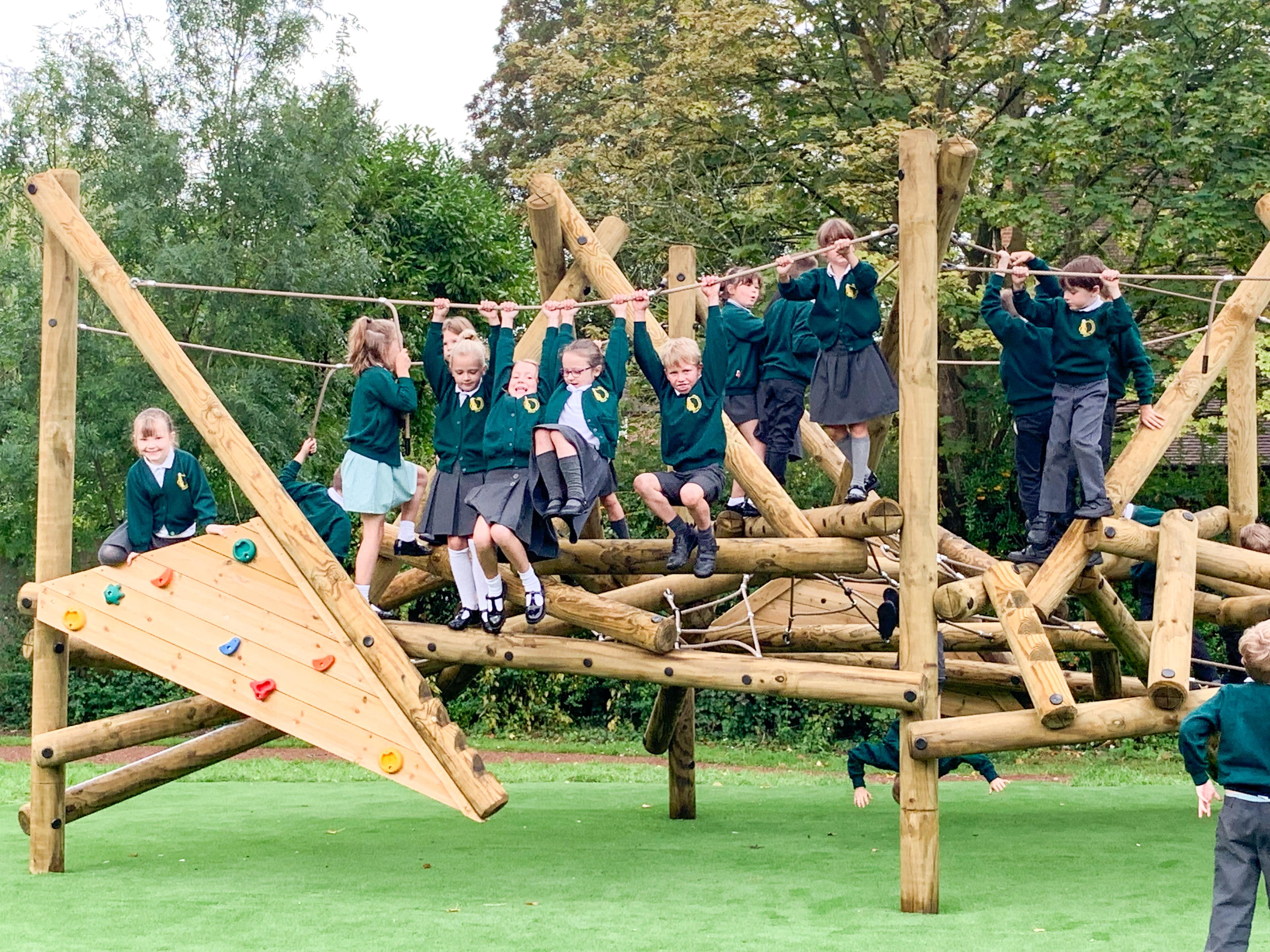 Wooden Crinkle Crags climbing frame in a school playground.