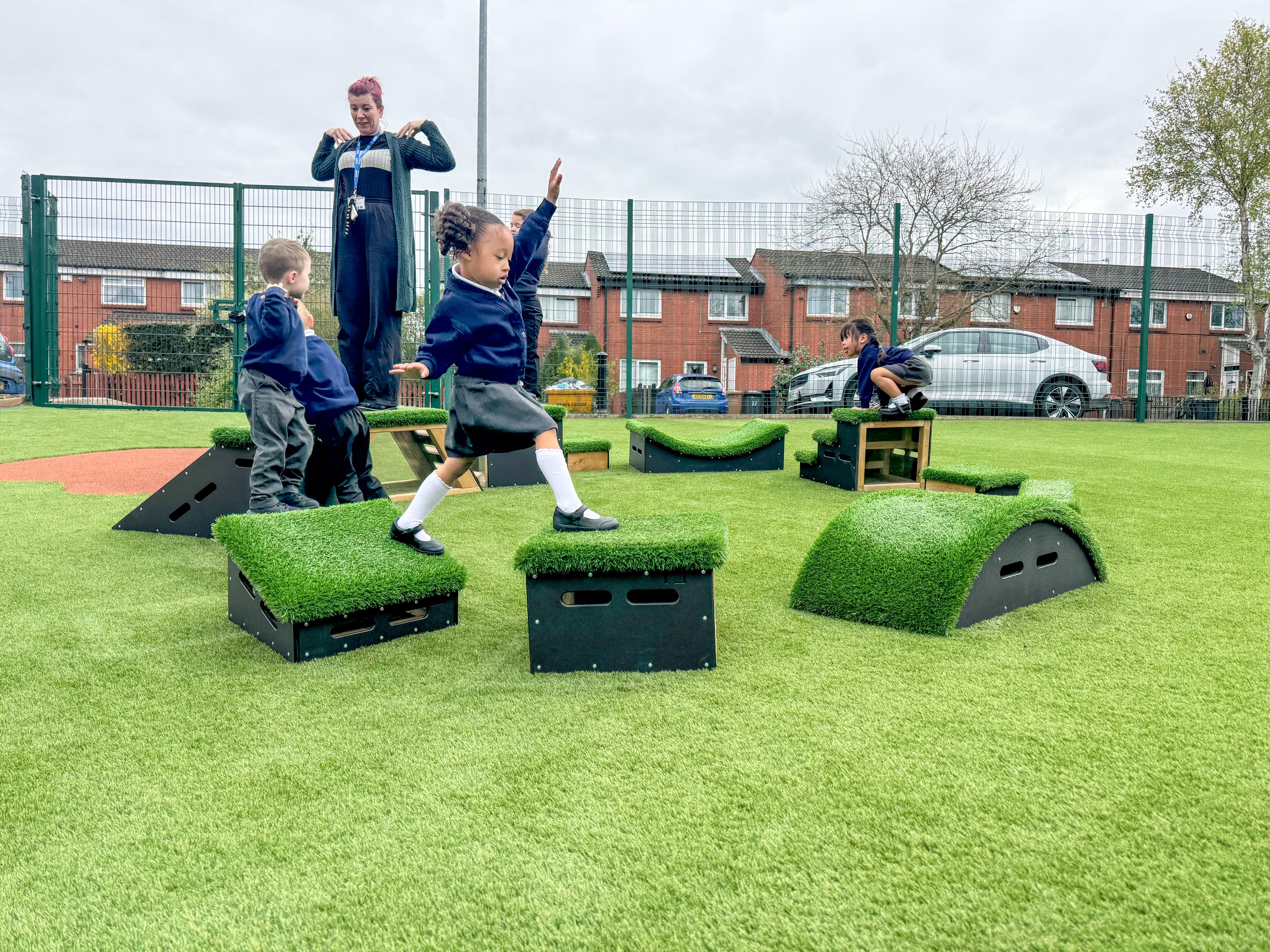 School children playing with grass-topped Get Set, Go! Blocks - The Mendips Set.
