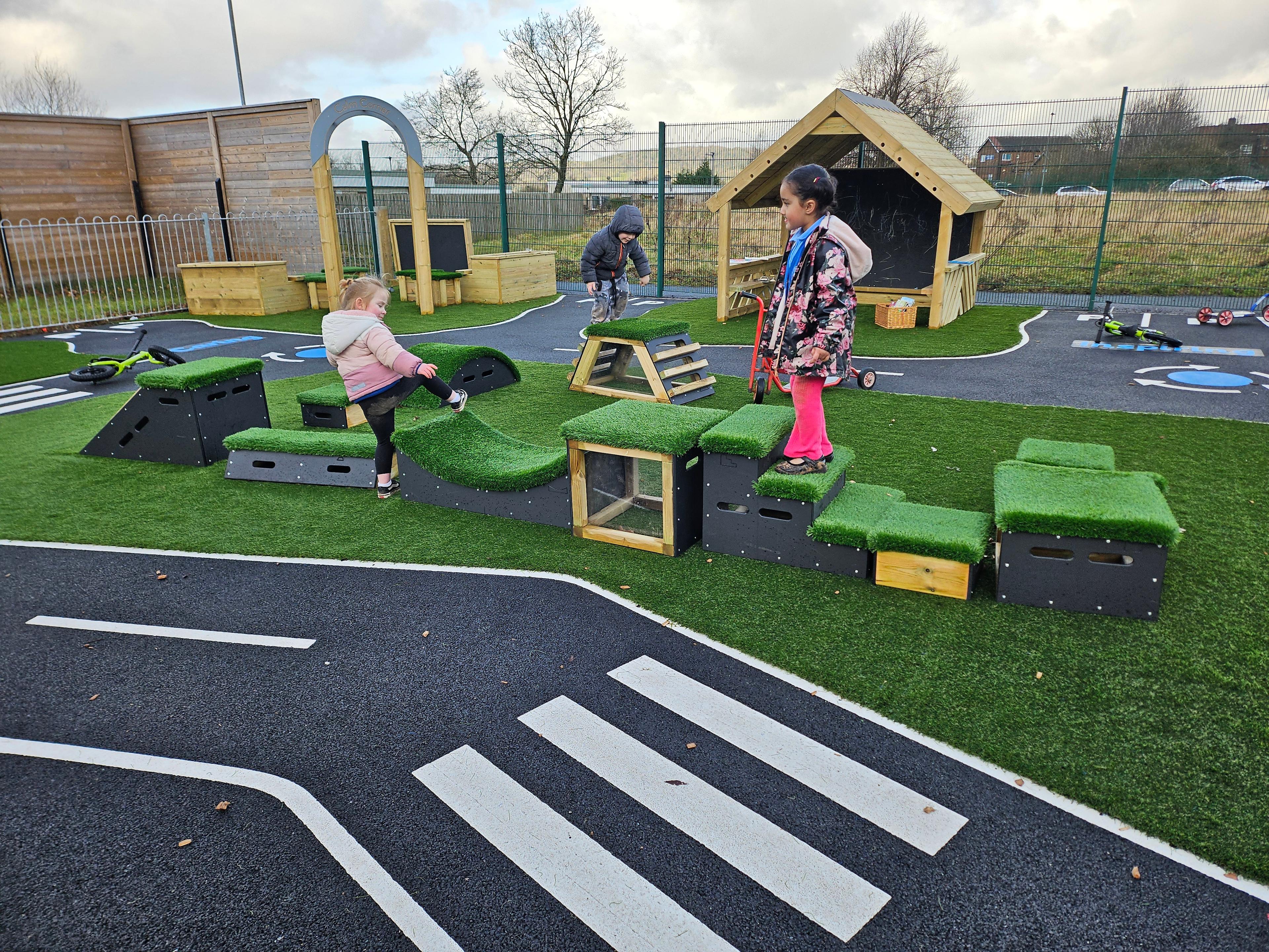 School children playing with grass-topped Get Set, Go! Blocks - The Mendips Set.