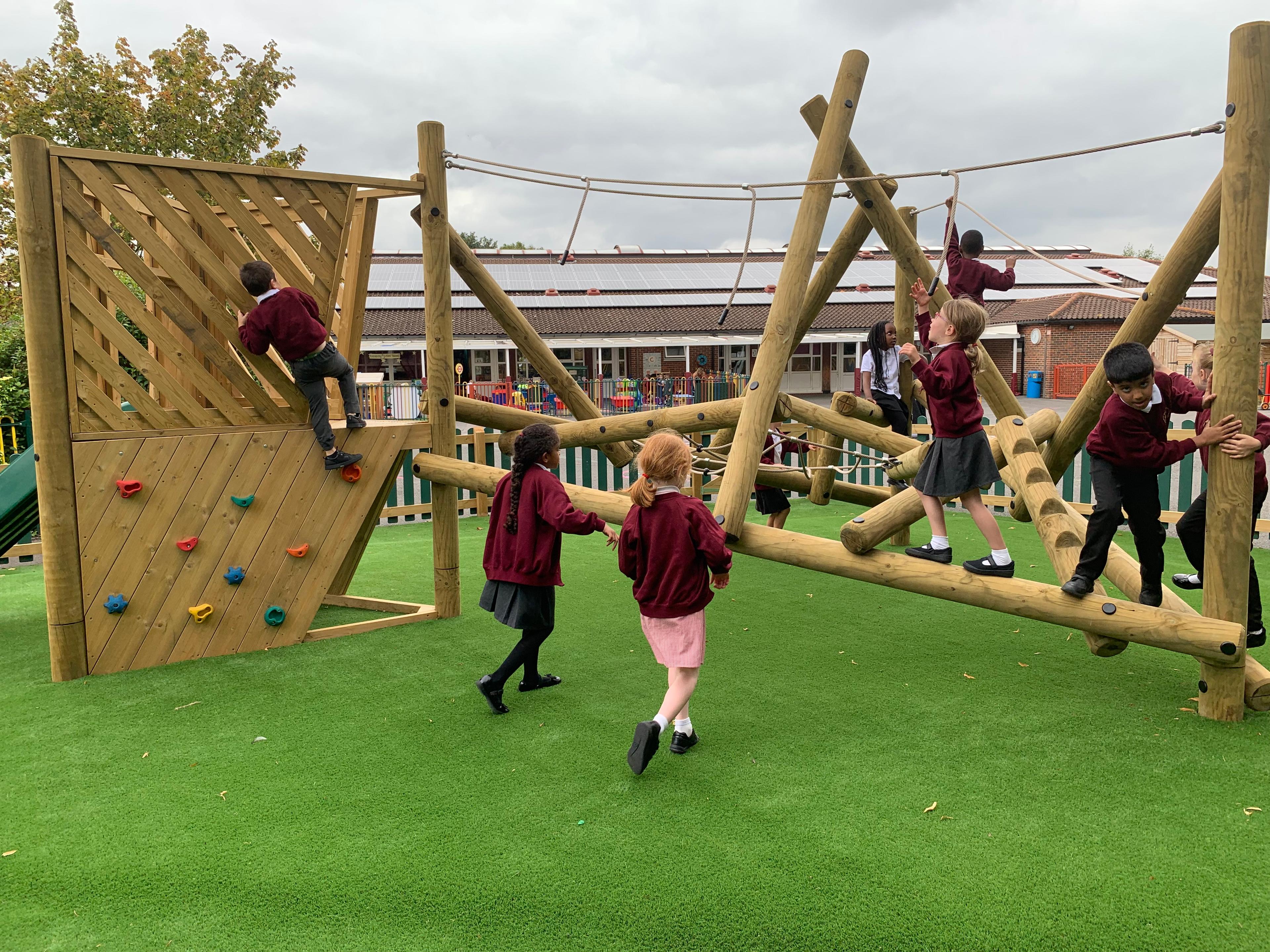 Wooden Bowfell Climbing Frame with Platform and Slide in school playground.