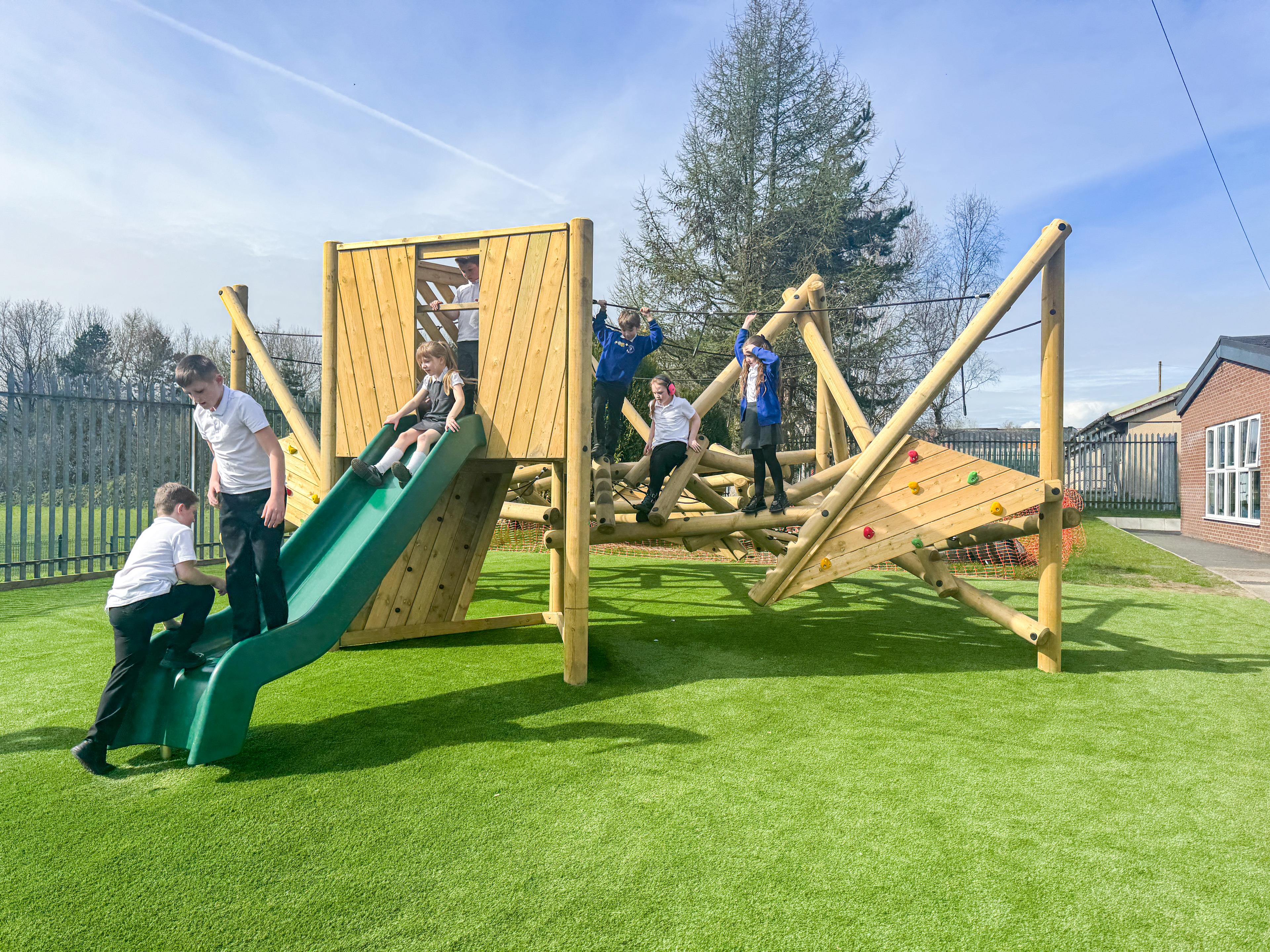 Children climbing on and sliding down the Crinkle Crags Climber with Platform and Slide