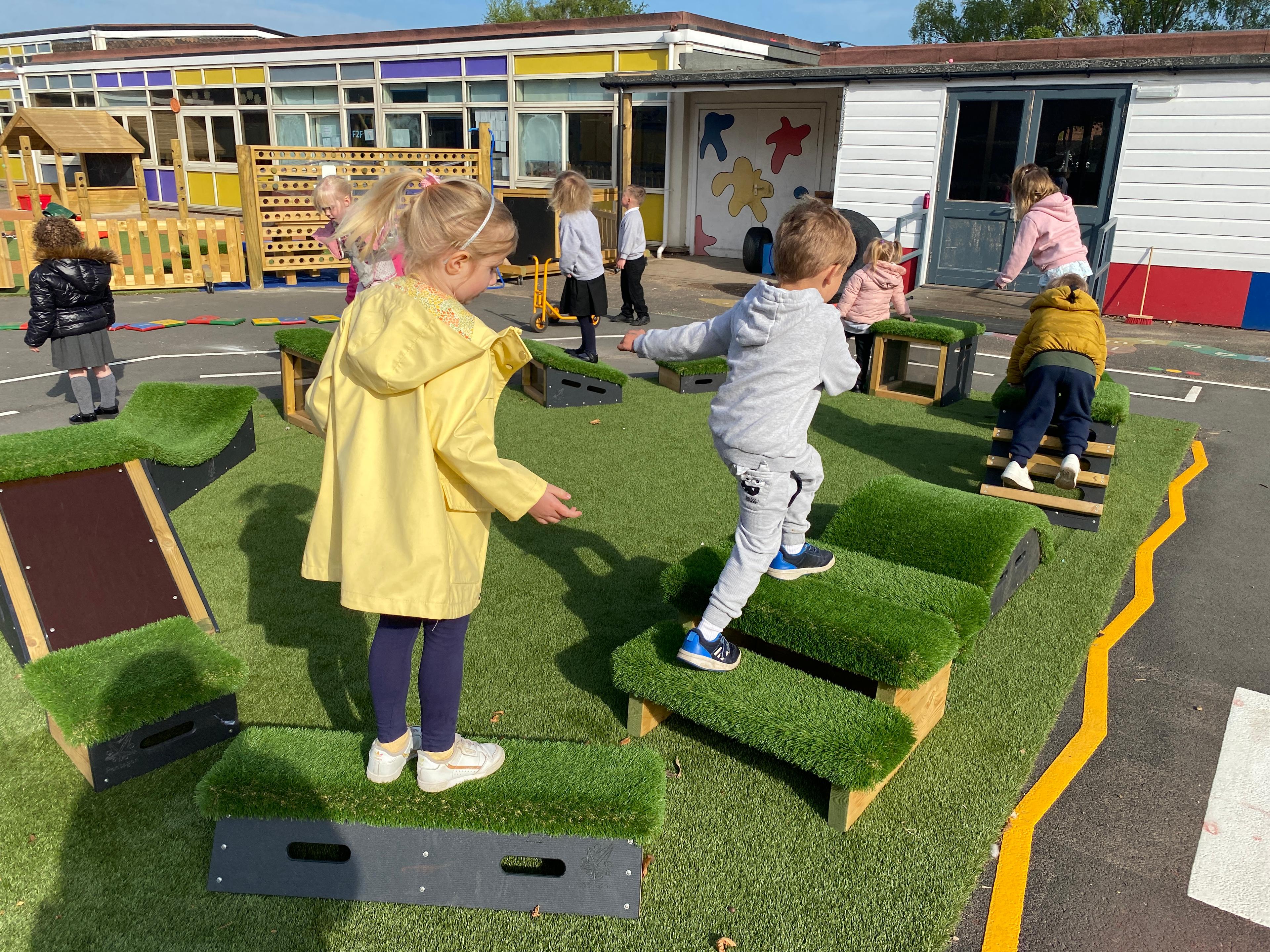 School children playing with grass-topped Get Set, Go! Blocks - The Mendips Set.