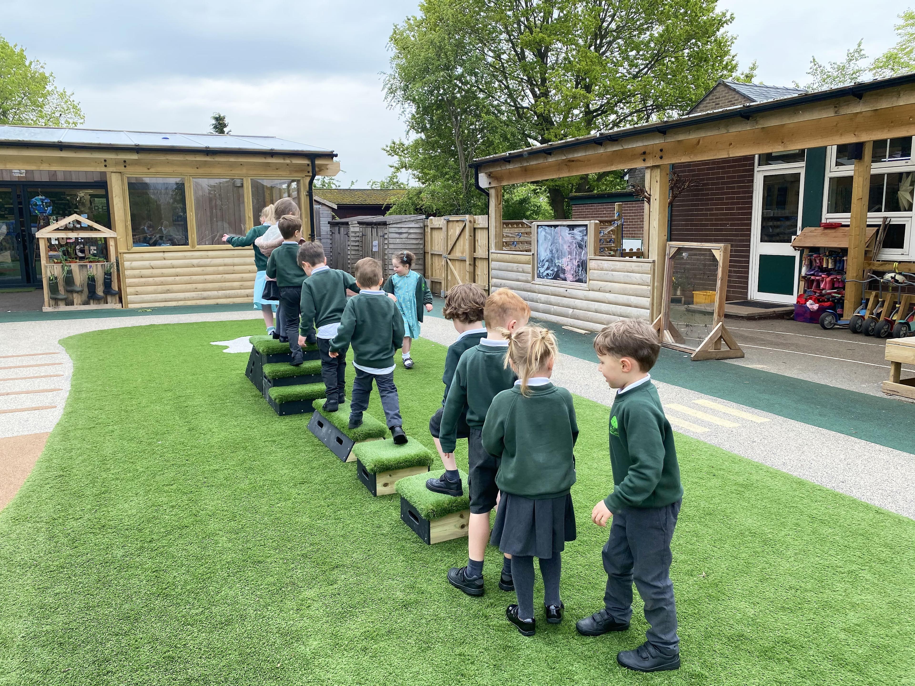 A line of children are playing with the Get Set Go Blocks The Chilterns Set.