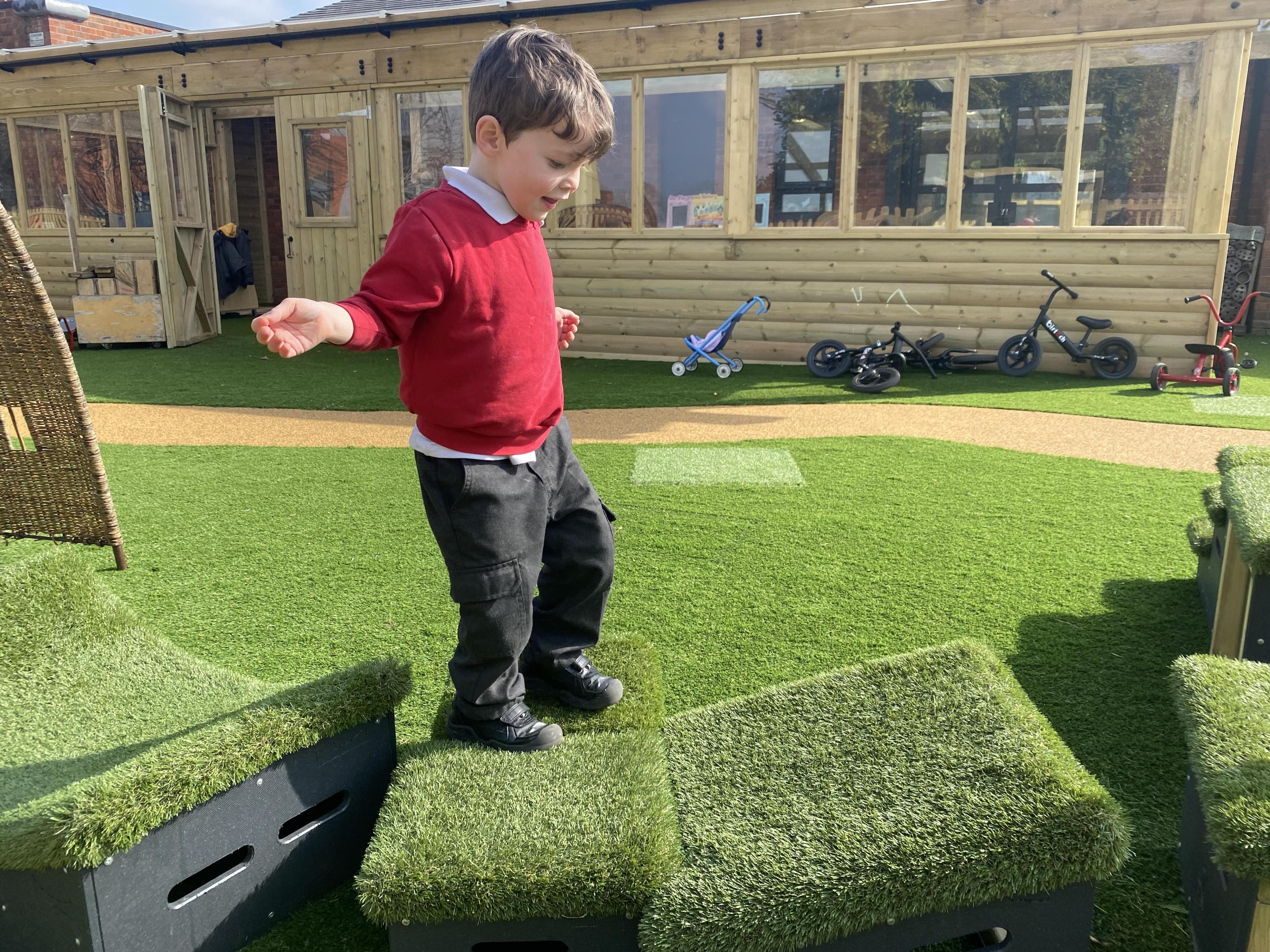 Little boy is balancing across Get Set Go Blocks