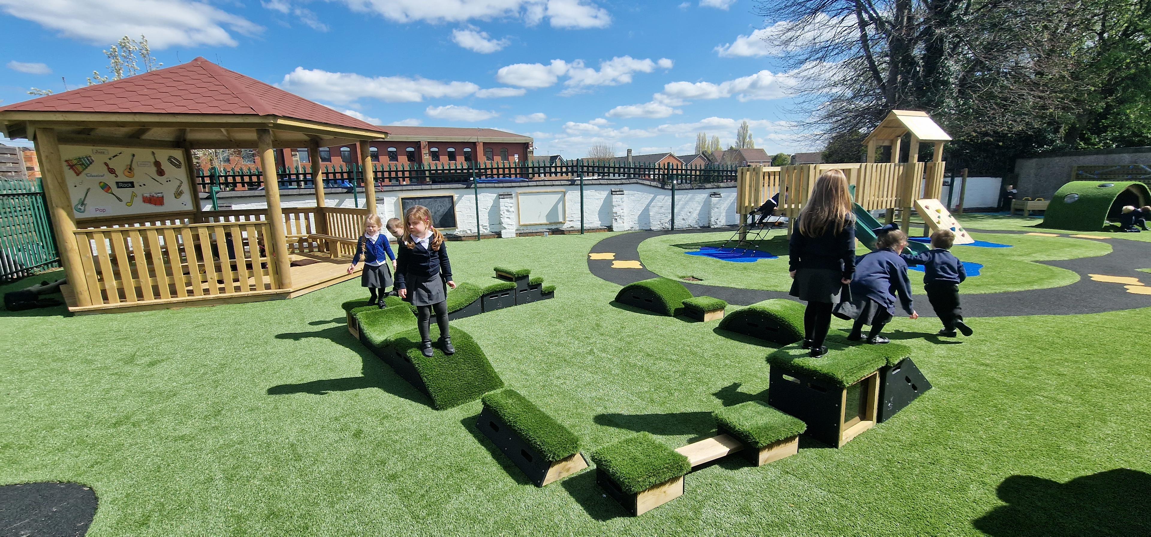School children playing with grass-topped Get Set, Go! Blocks - The Mendips Set.