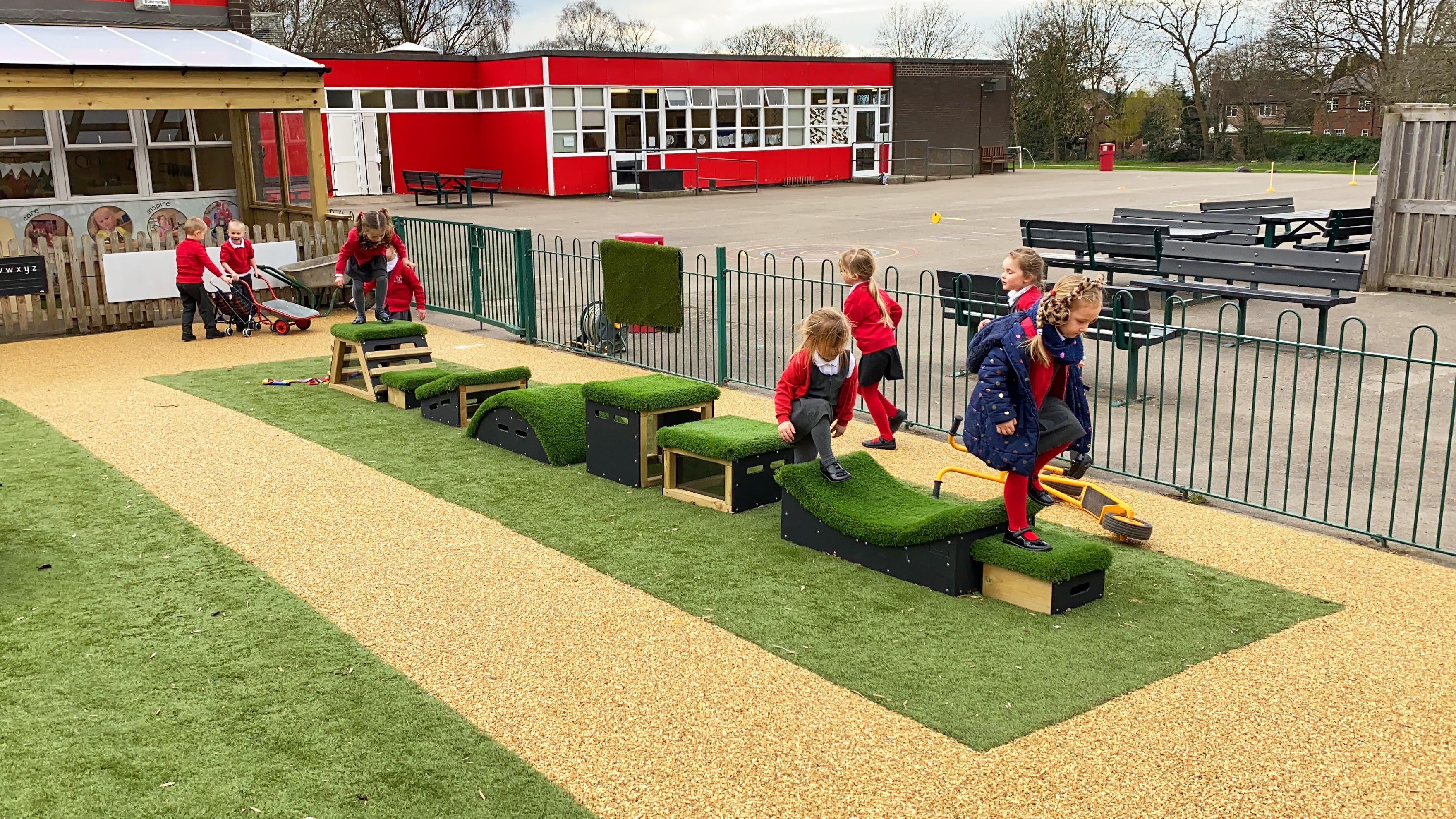 School children playing with grass-topped Get Set, Go! Blocks - The Mendips Set.