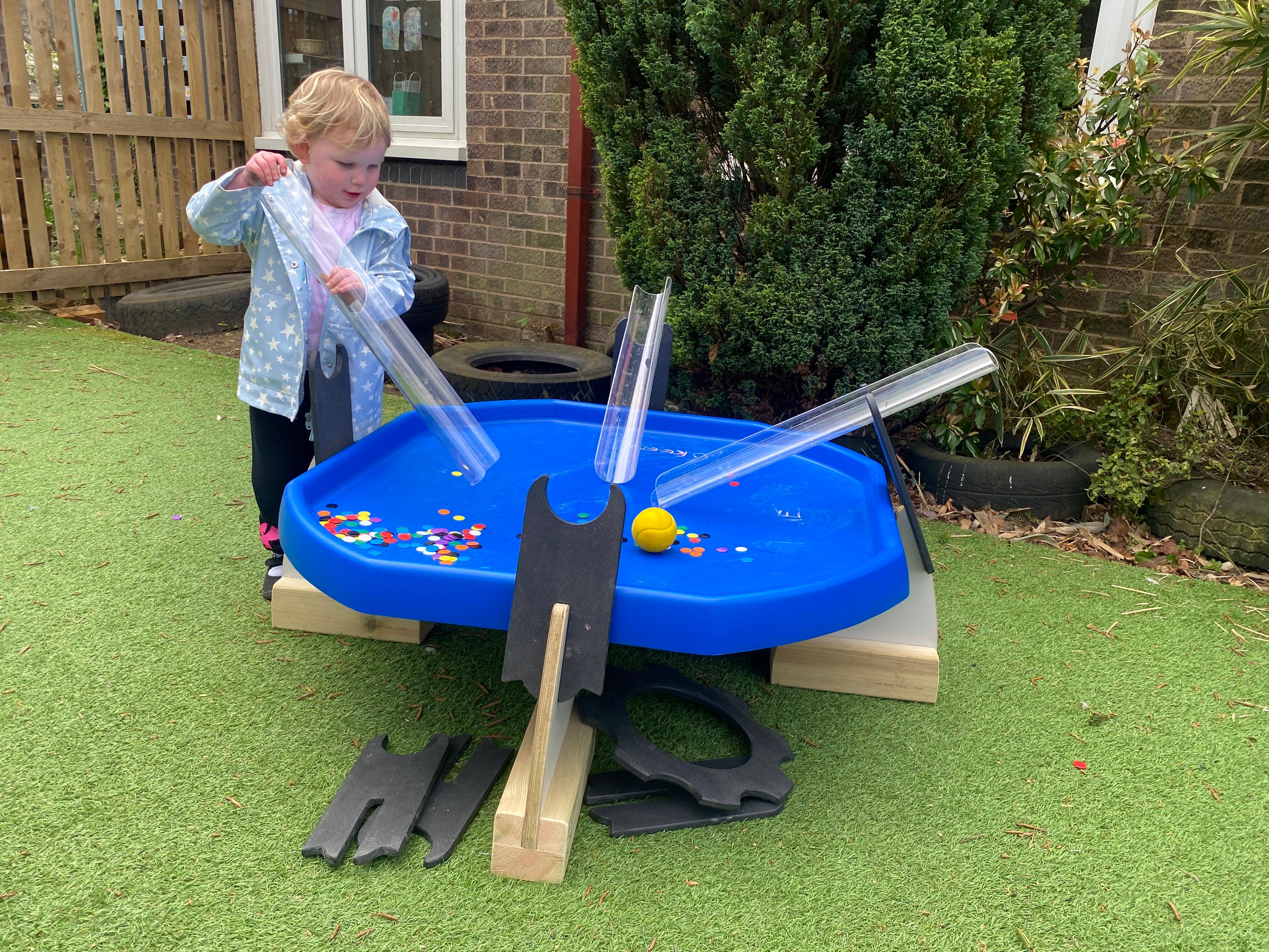 Children playing with a Pentagon Tuff Spot Table