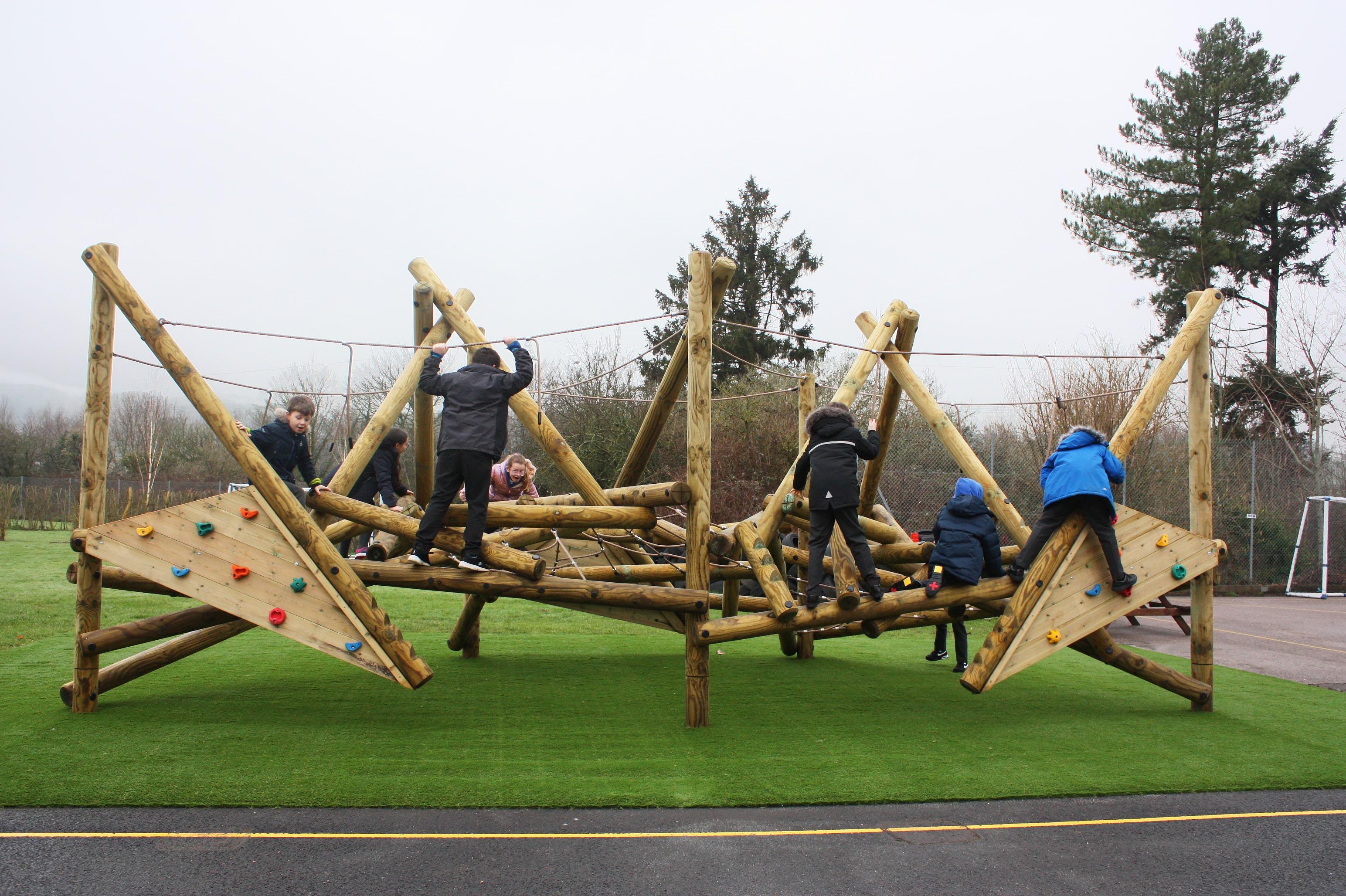 Group of children exploring the Crinkle Crags Climber with Platform and Climbing Net and climbing.