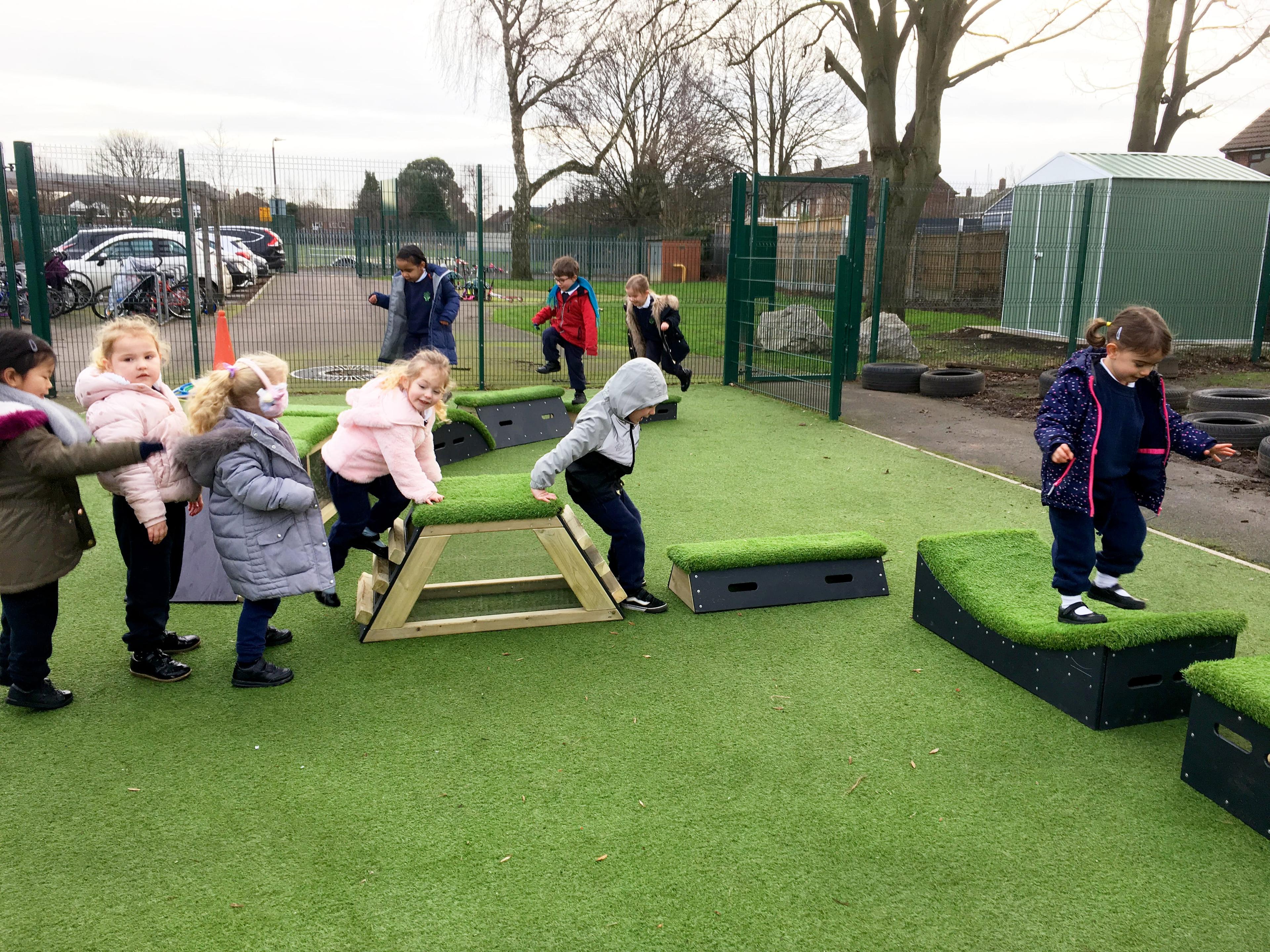A group of children are tackling an obstacle course made from Get Set Go Blocks.