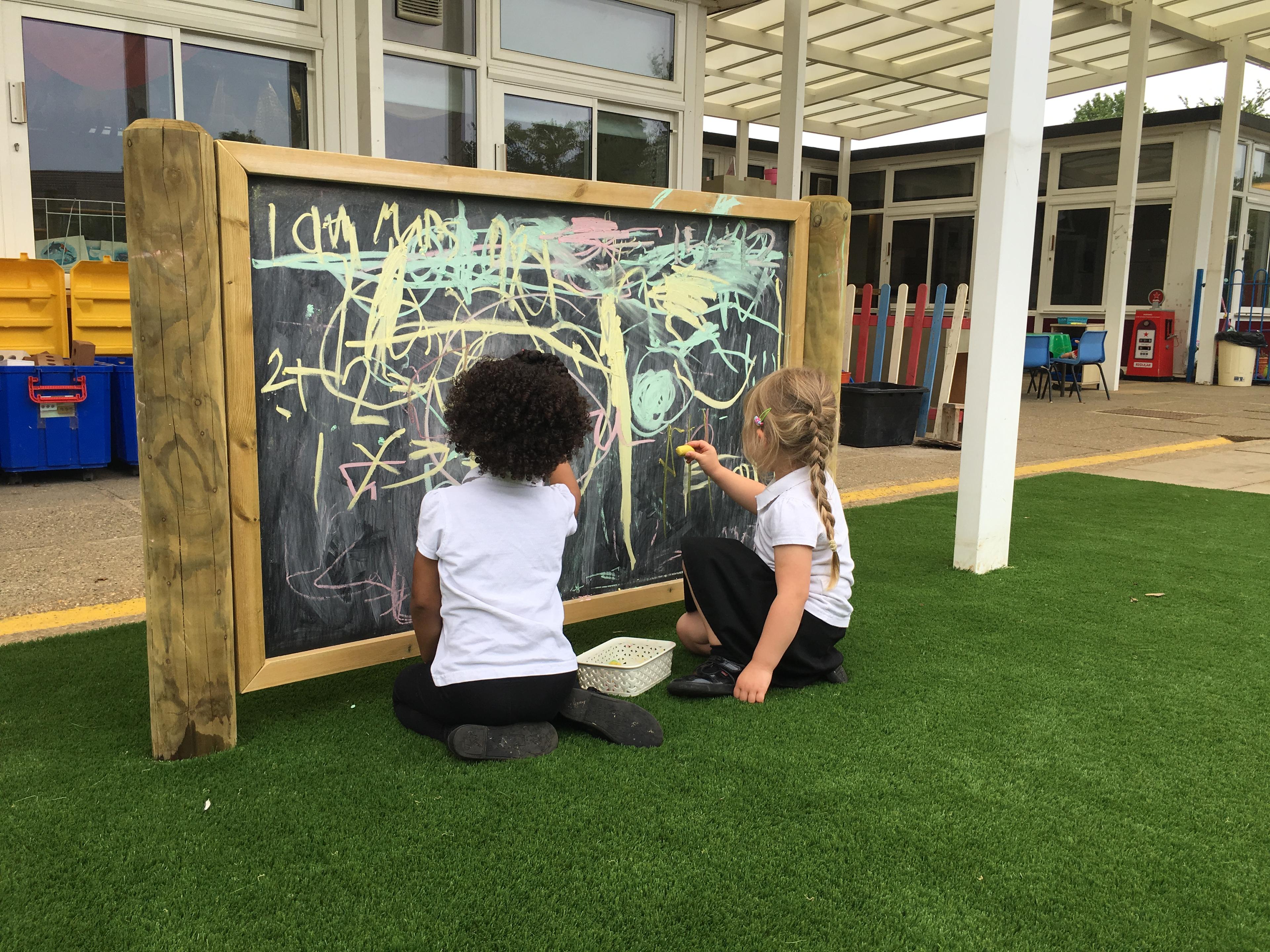 Giant wooden chalkboard on posts from Pentagon Play