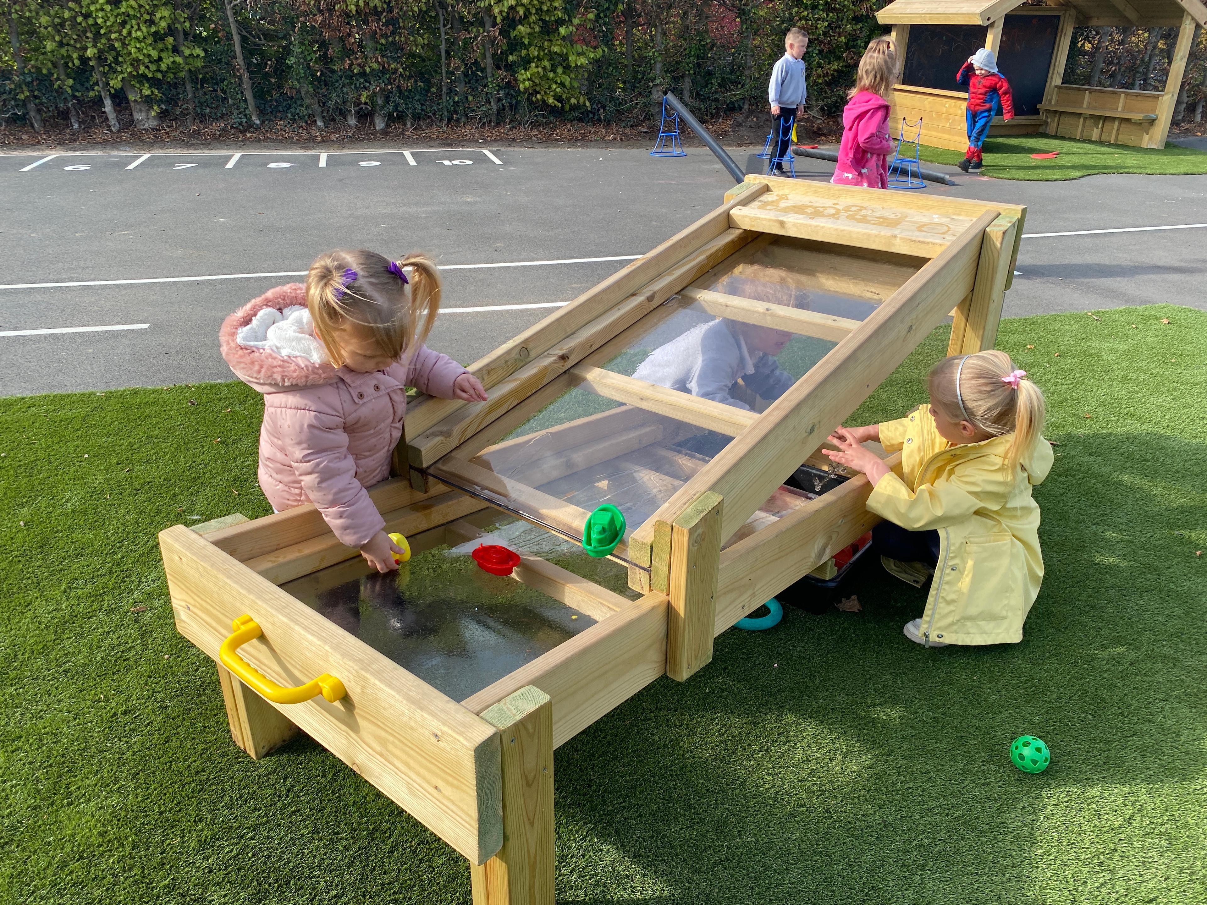 Two girls playing and experimenting with the Pentagon Play flow table