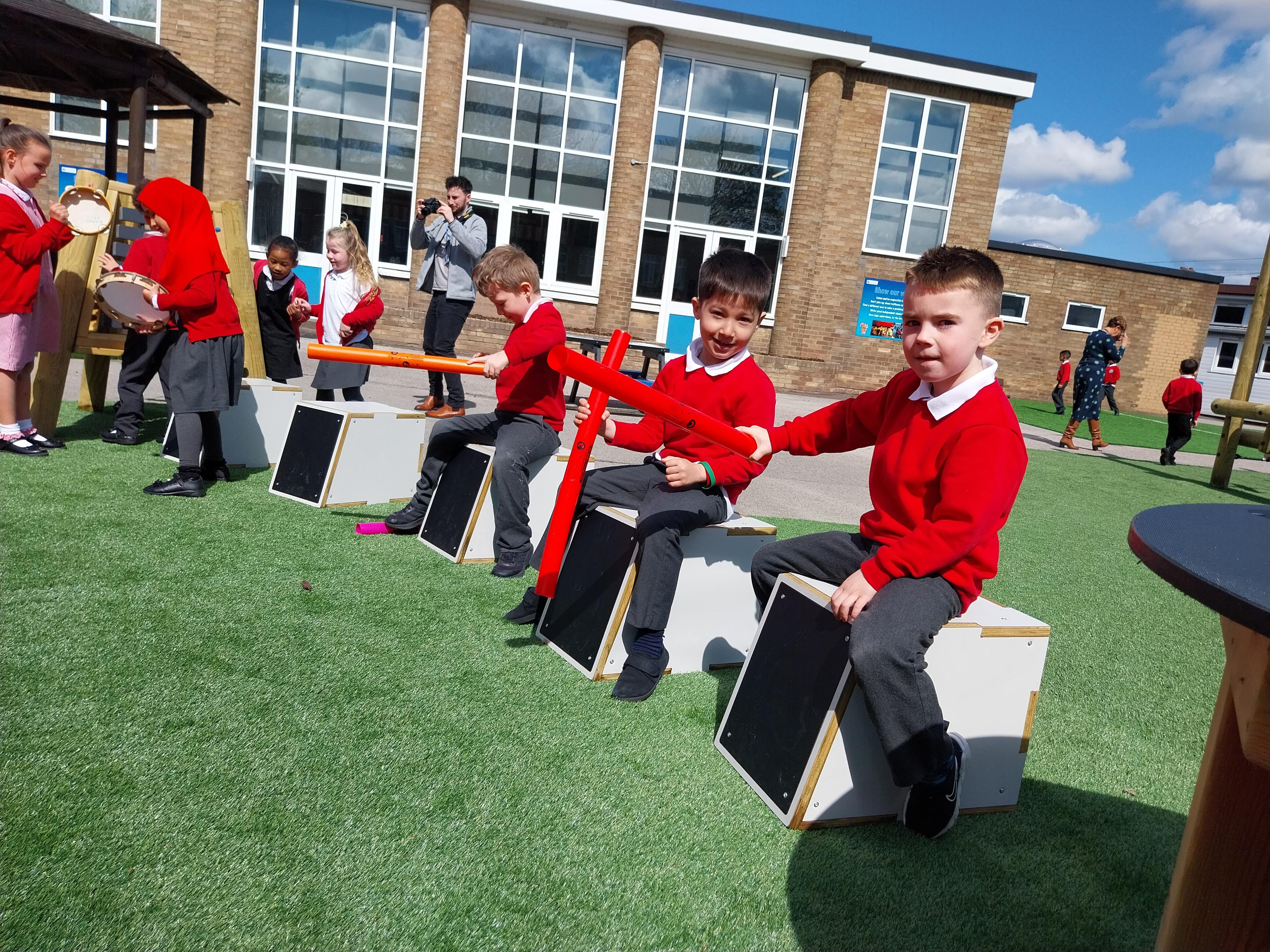 A group of children playing on drum seats