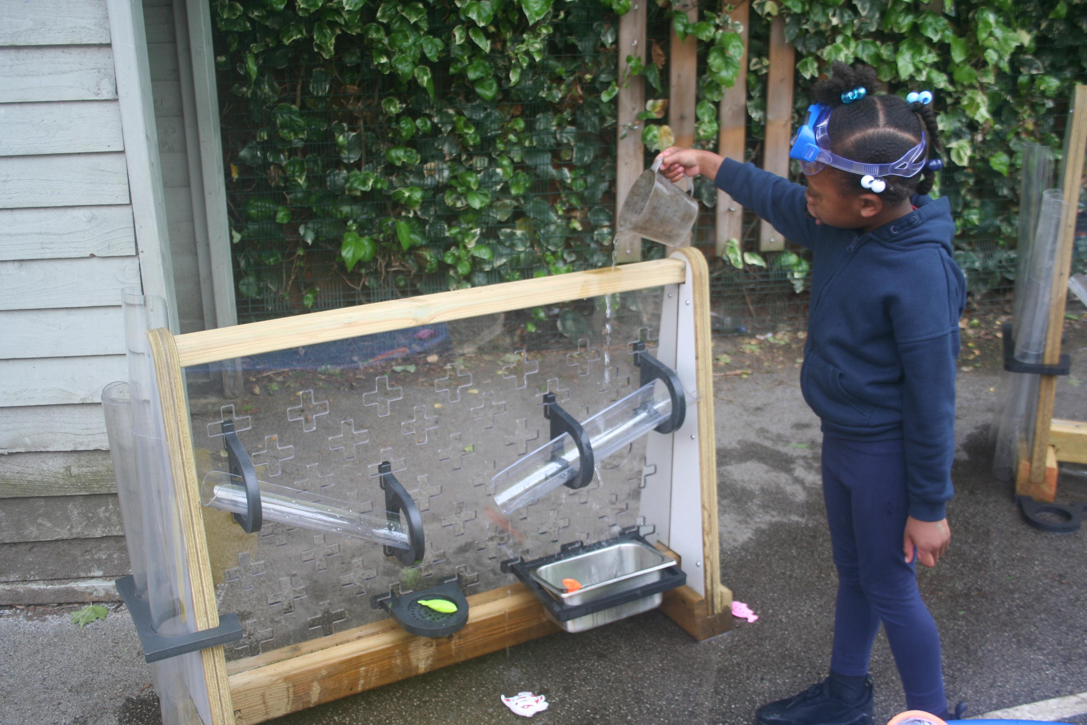 Children playing with a Pentagon Mini Water Wall.