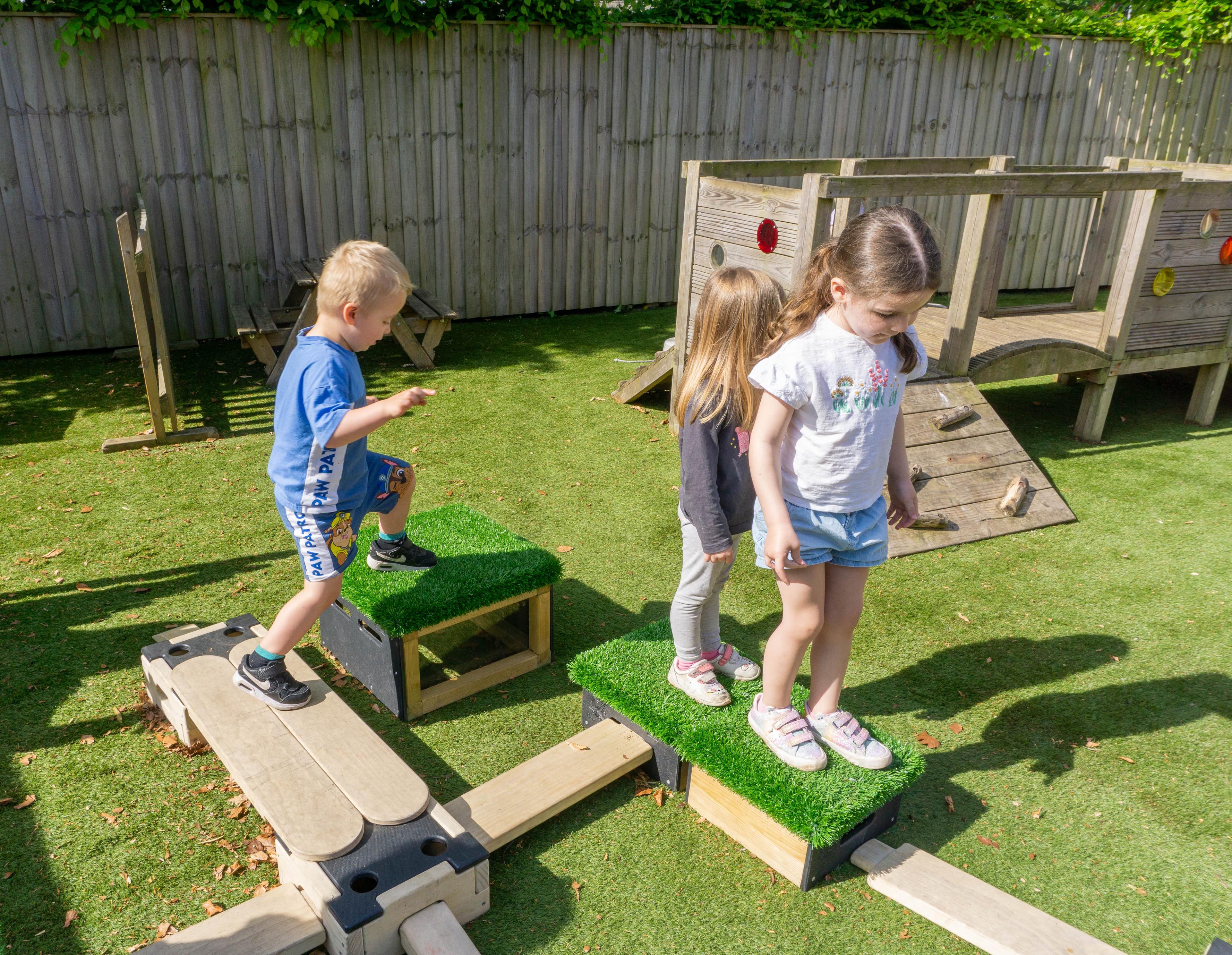 EYFS children are playing on an obstacle course that has been made from Play Builder and Get Set Go Blocks.
