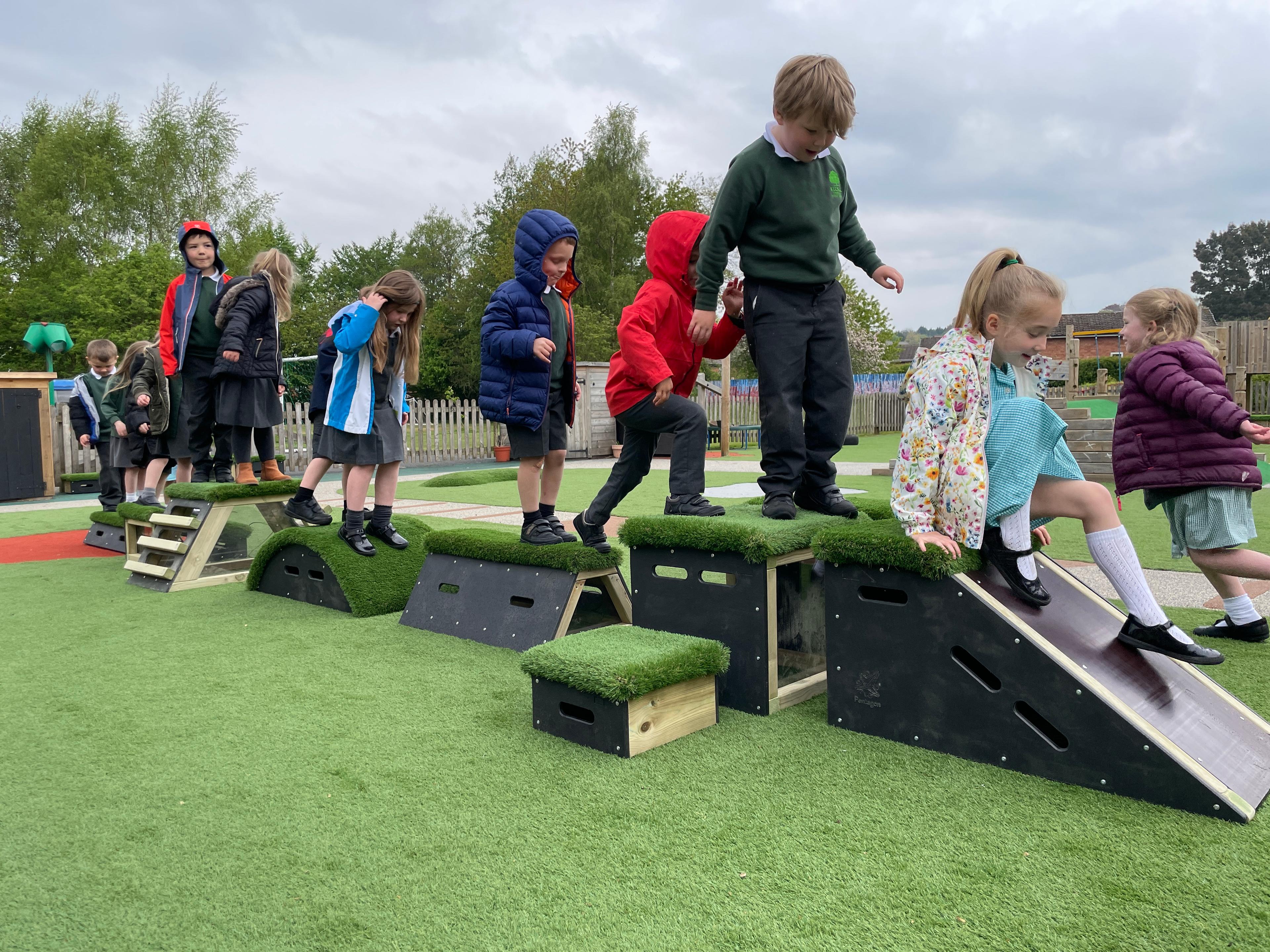 A large group of children walking along a line of Get Set, Go! Blocks