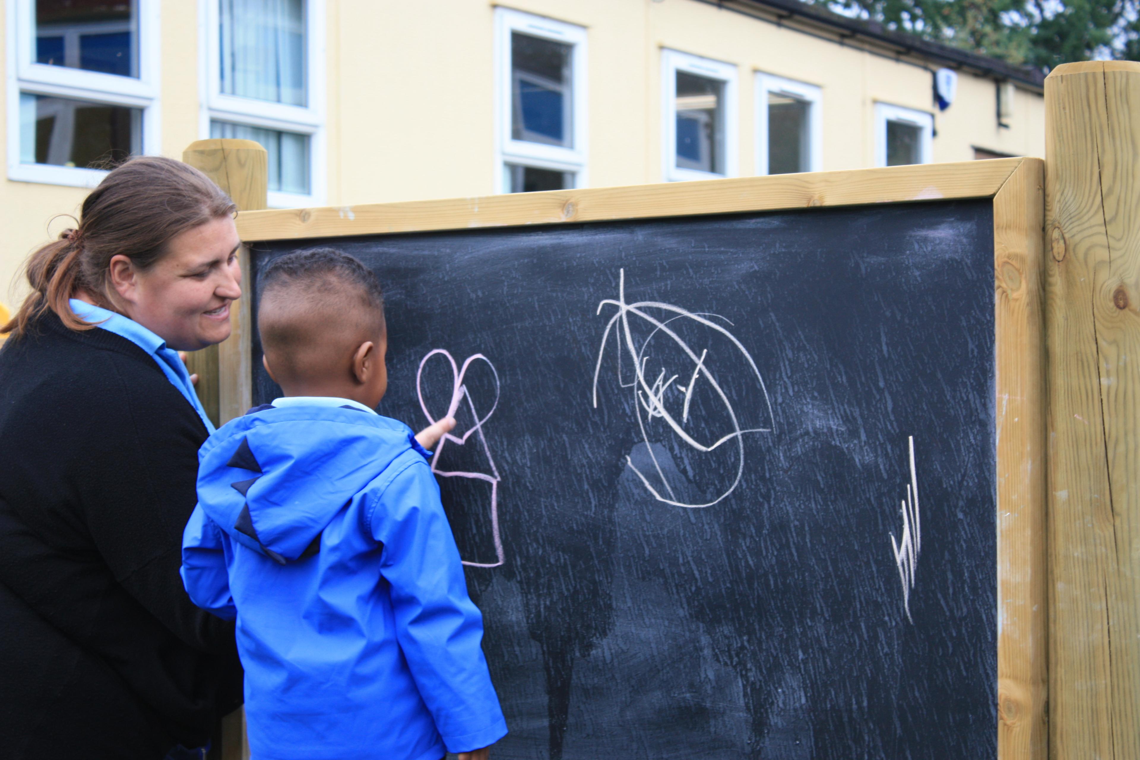 Giant wooden chalkboard on posts from Pentagon Play