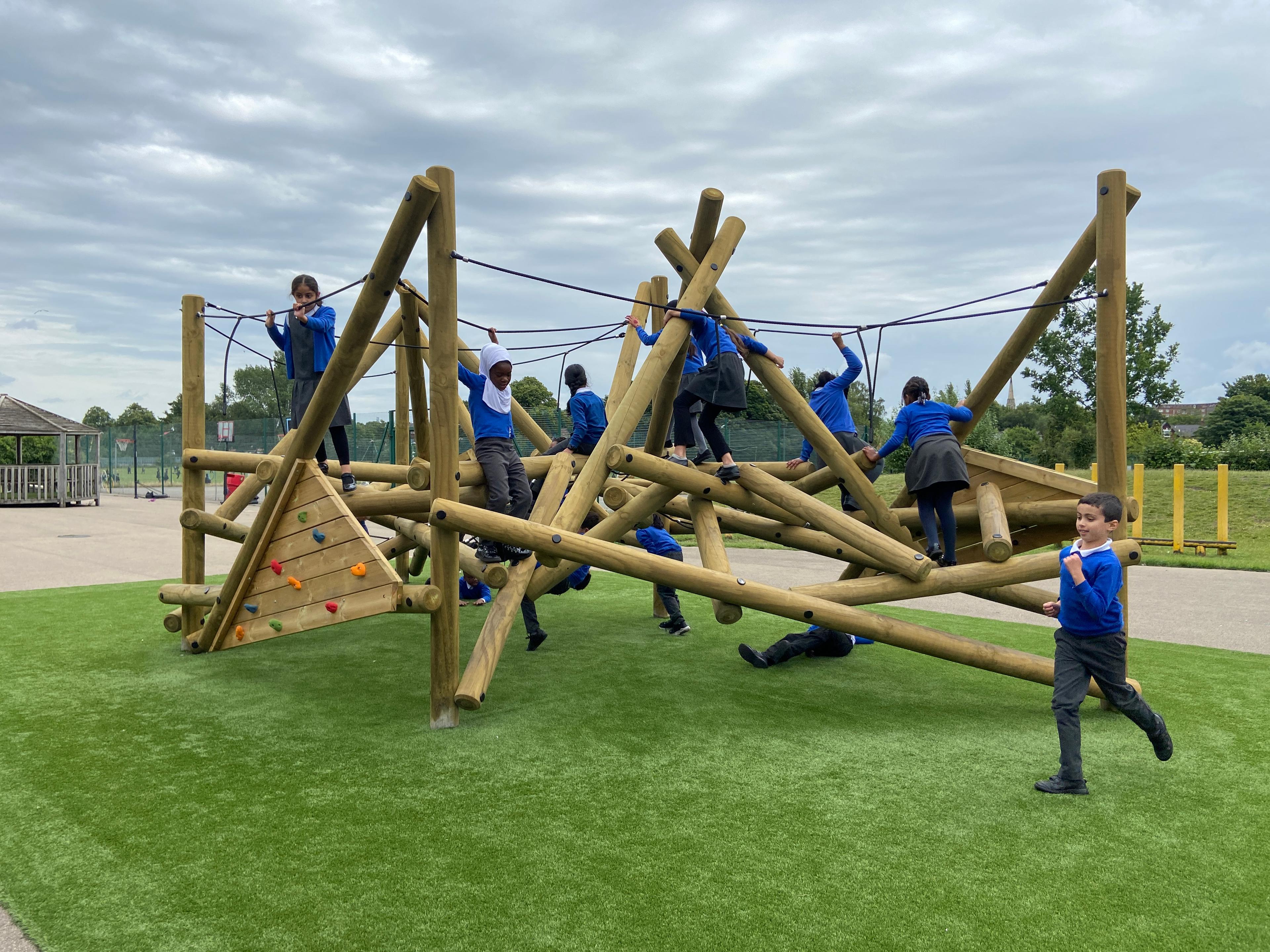 Wooden Crinkle Crags climbing frame in a school playground.