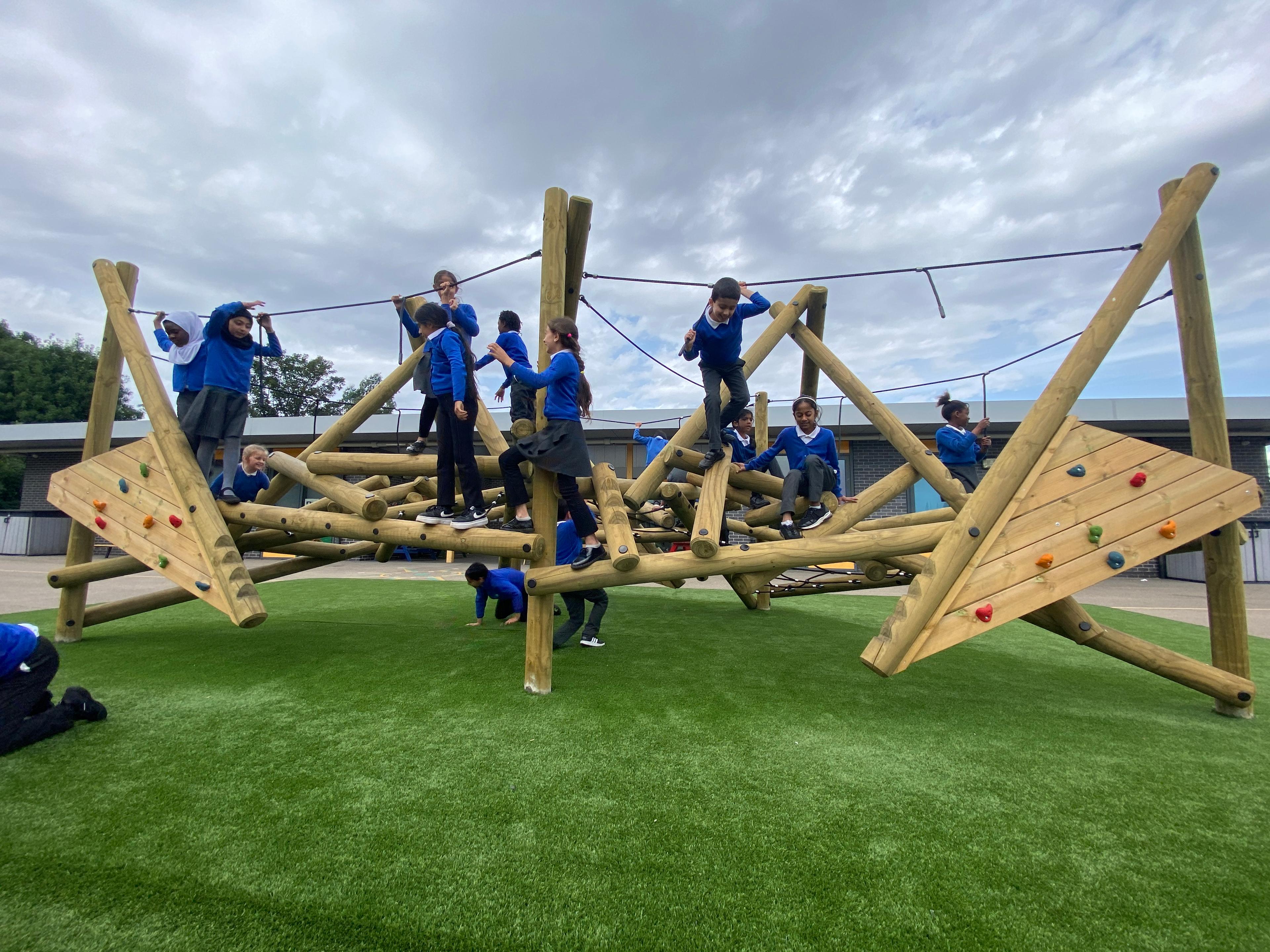 Wooden Crinkle Crags climbing frame in a school playground.