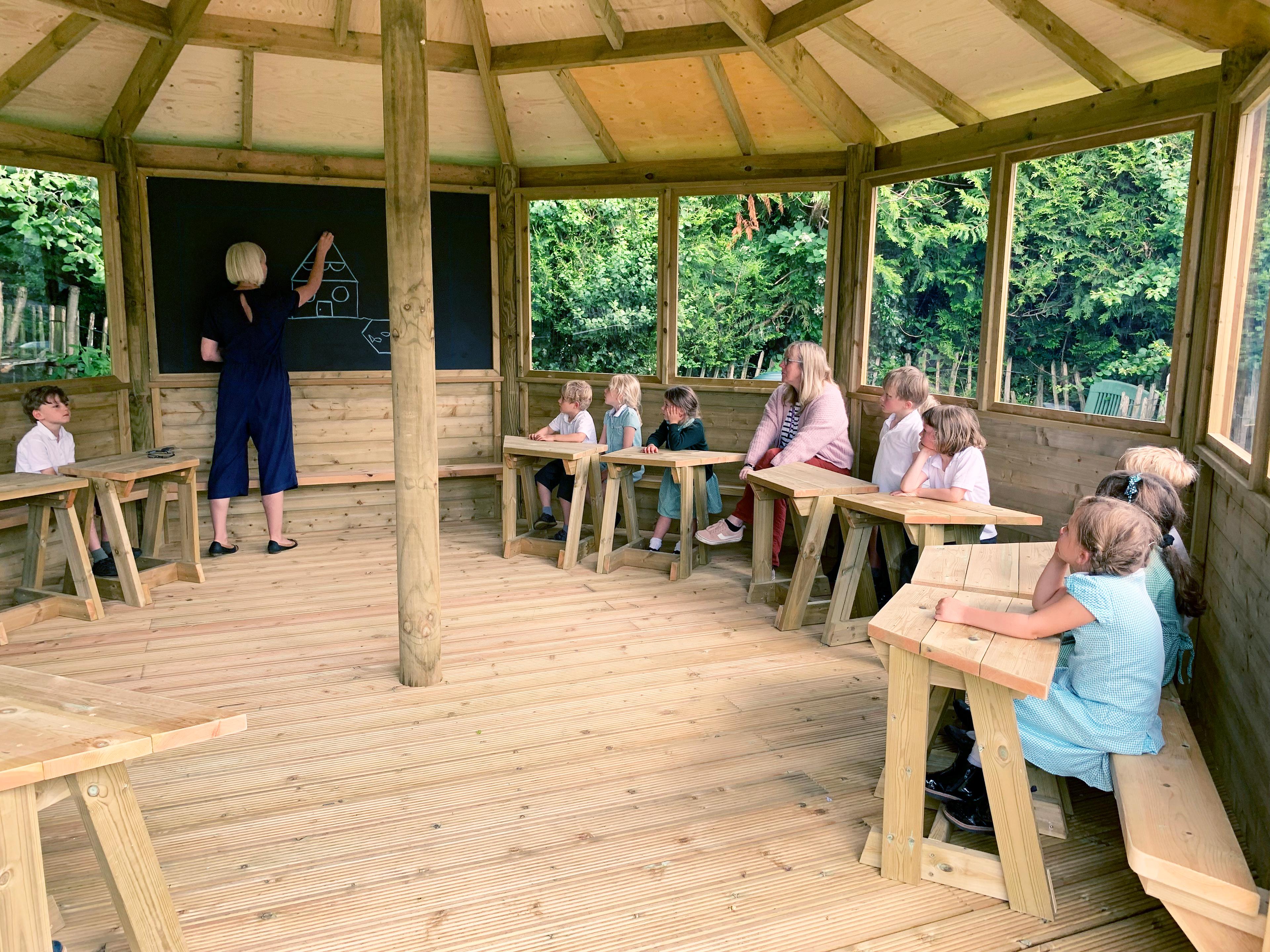 Wooden 6m Octagonal Gazebo with decked base in a school playground.