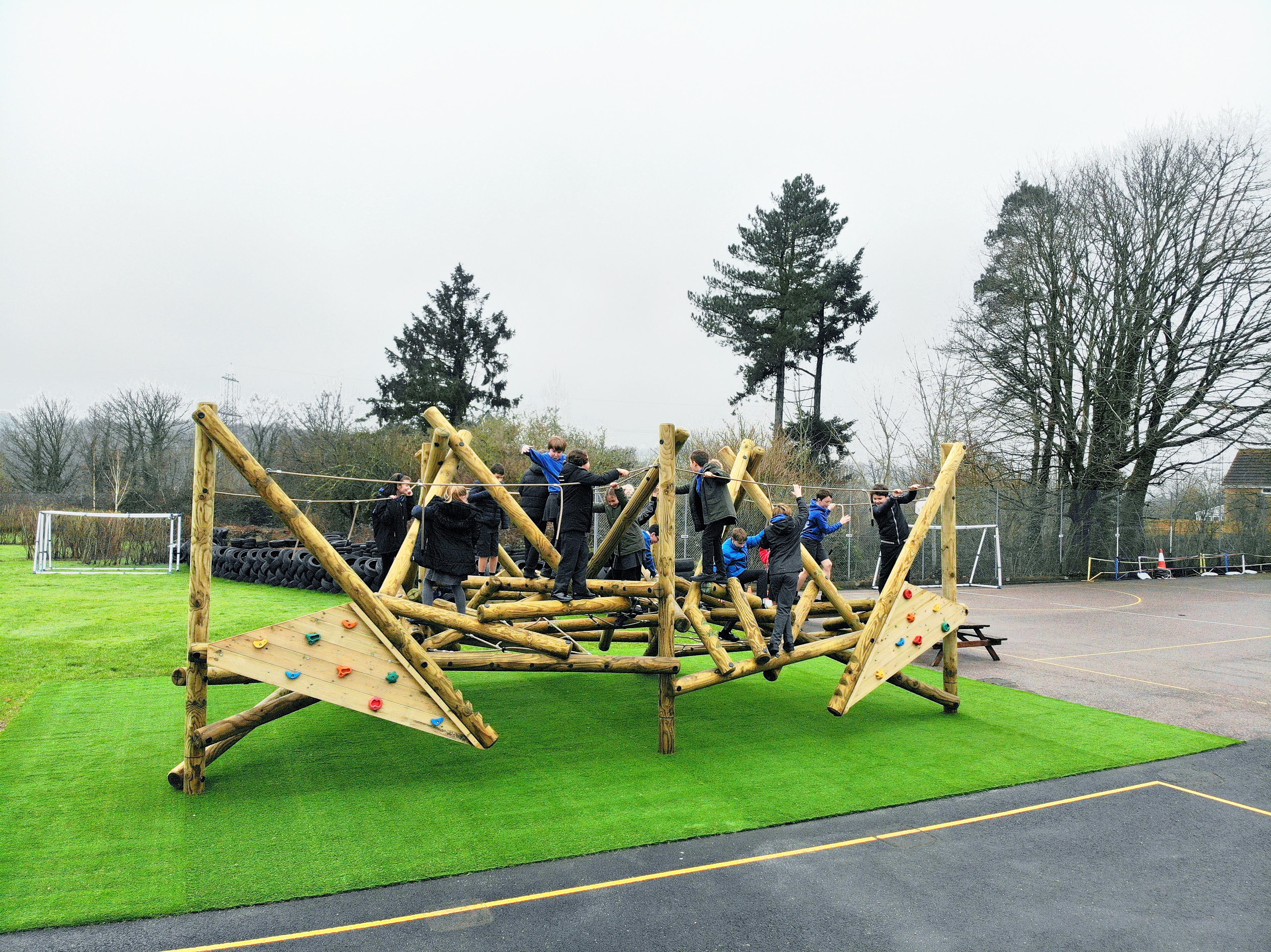 Wooden Crinkle Crags climbing frame in a school playground.