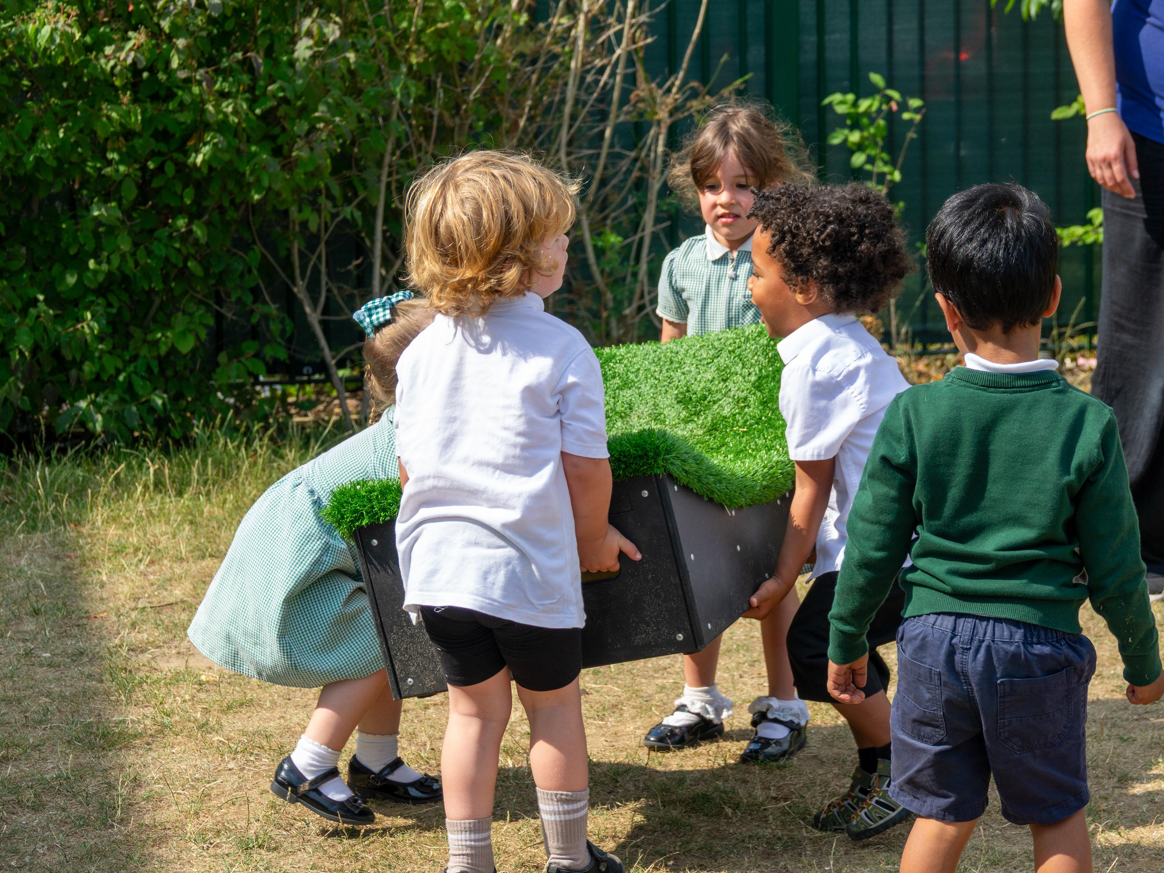 4 children carrying a Get Set, Go! Block