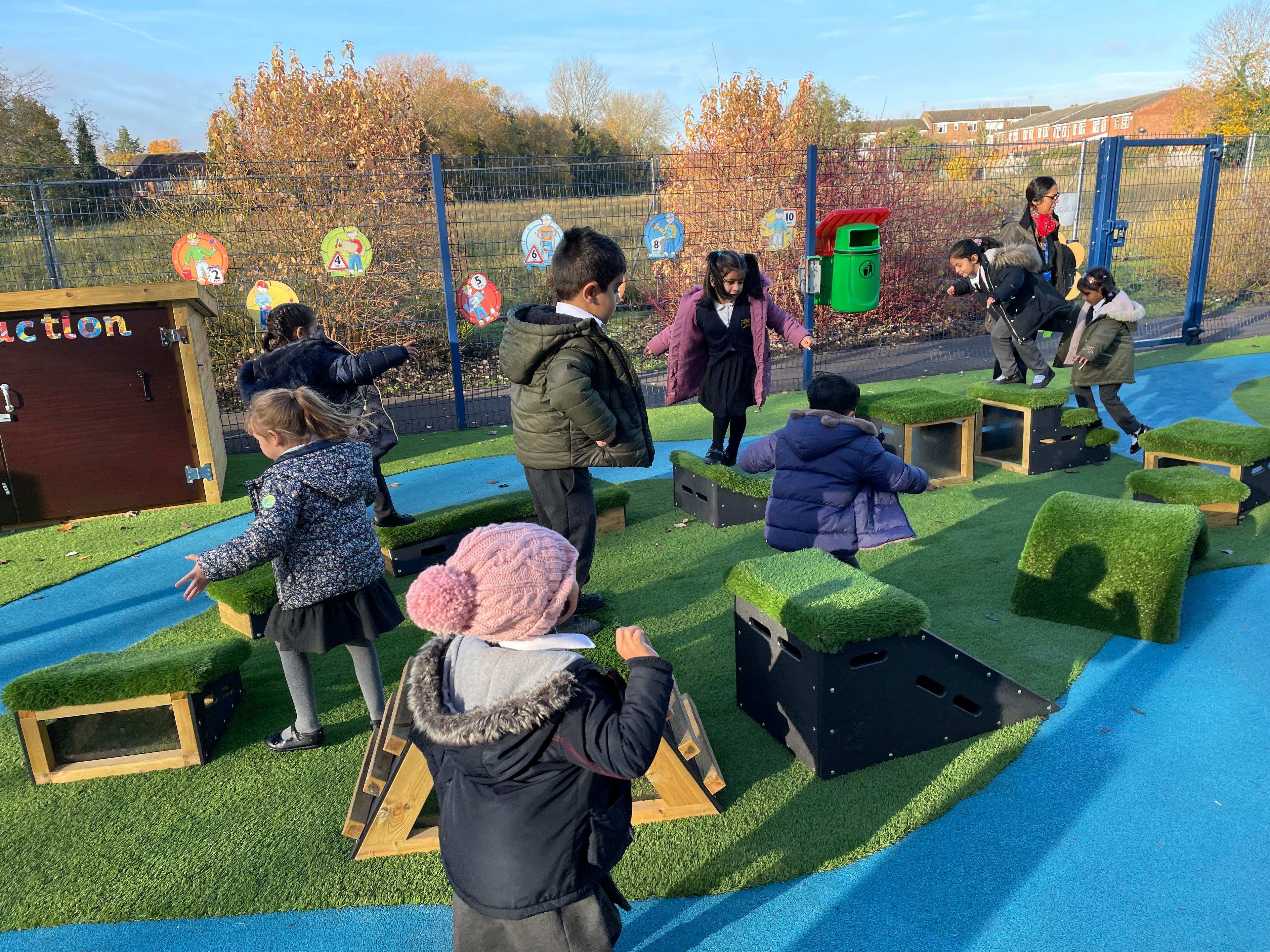School children playing with grass-topped Get Set, Go! Blocks - The Mendips Set.