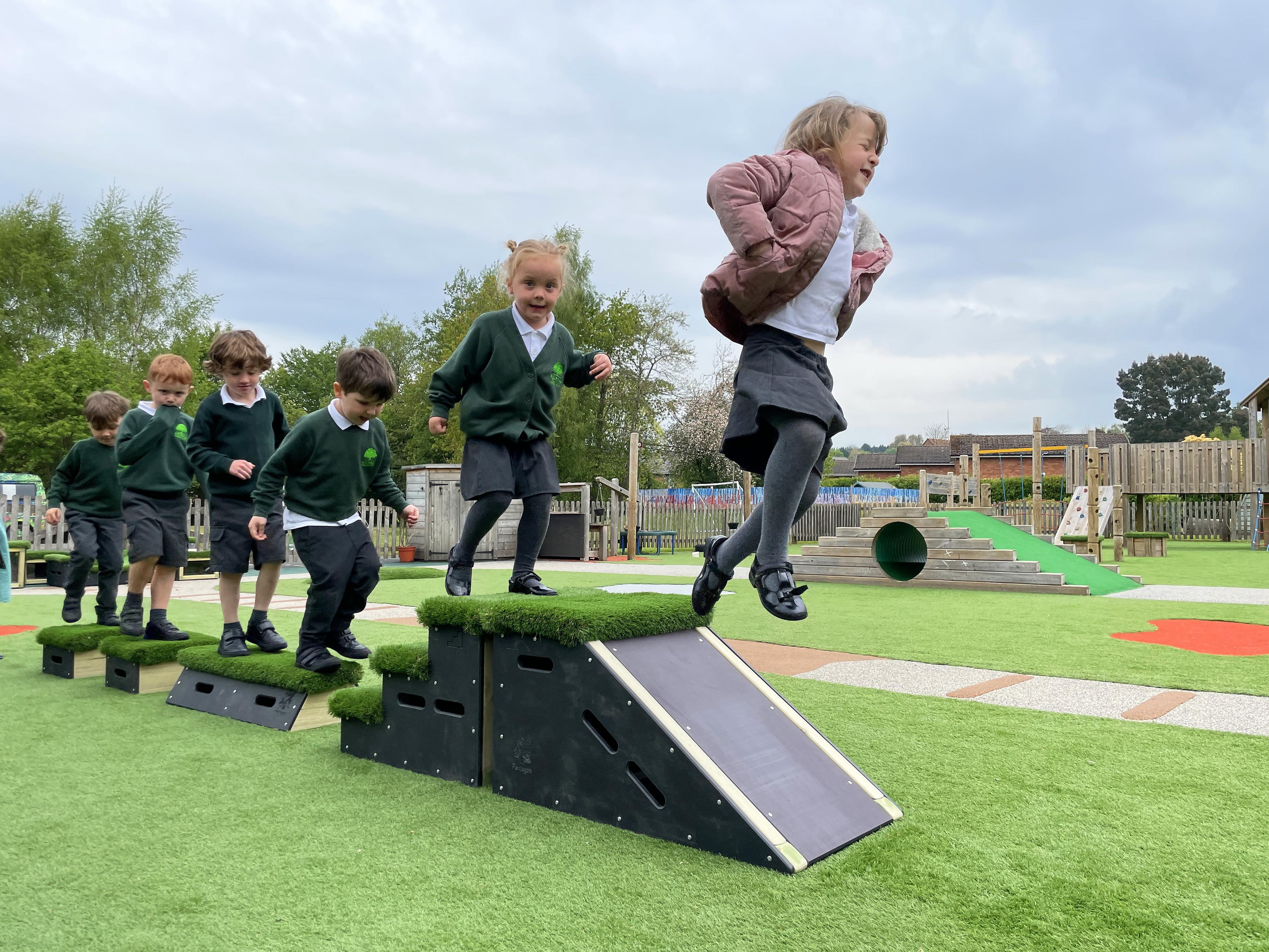 School children playing outside on grass-topped Get Set, Go! Blocks - The Chilterns Set.
