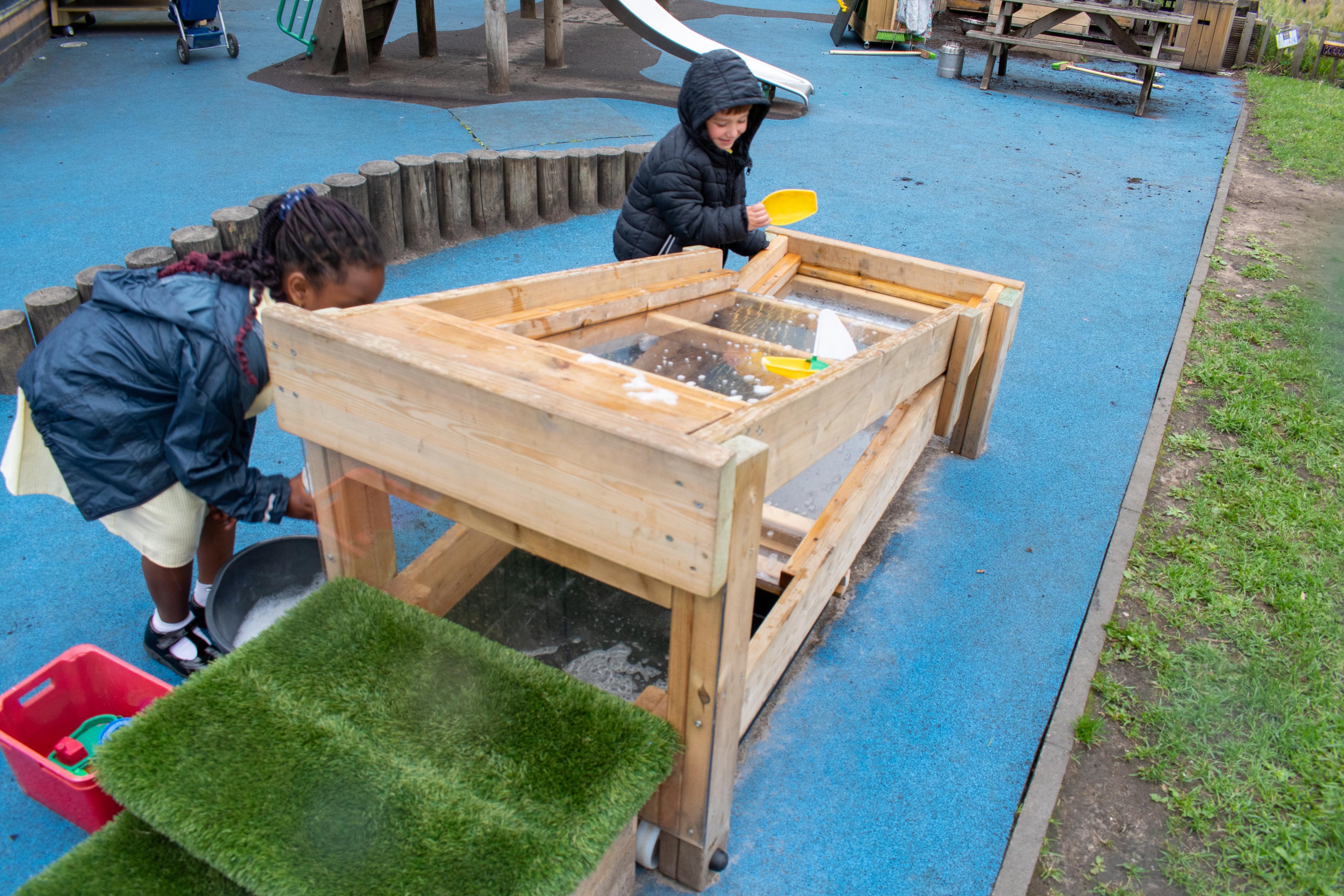 A young boy playing and experimenting with the Pentagon Play flow table