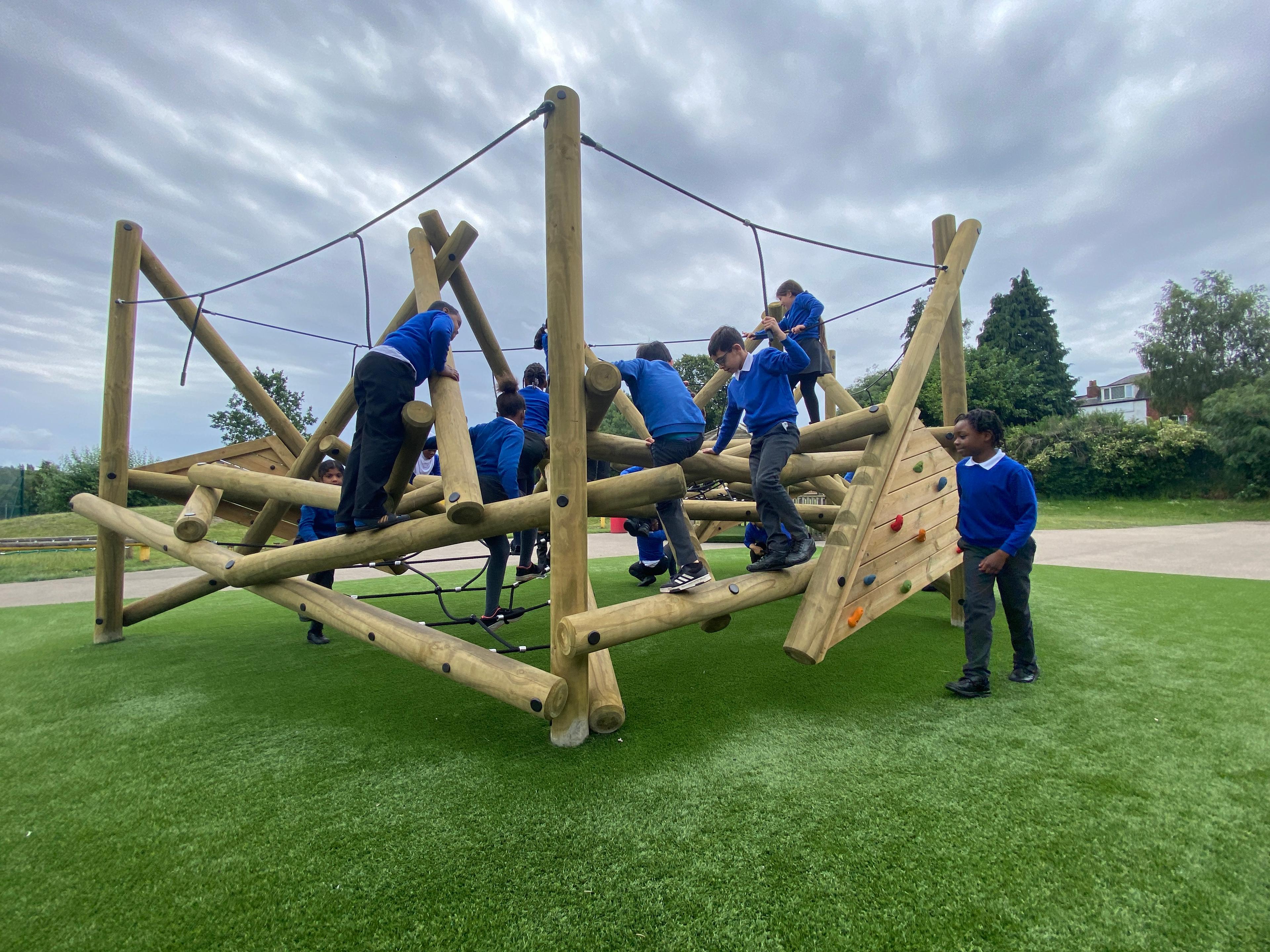 Wooden Crinkle Crags climbing frame in a school playground.