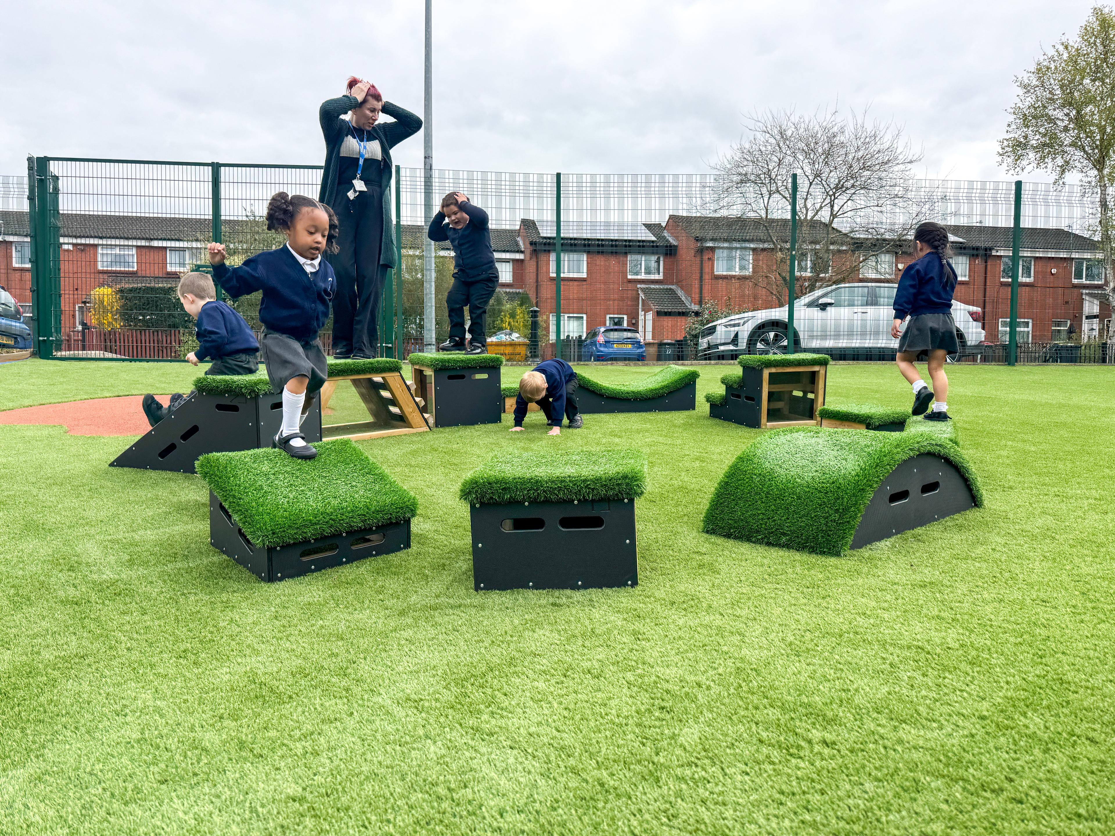 School children playing with grass-topped Get Set, Go! Blocks - The Mendips Set.