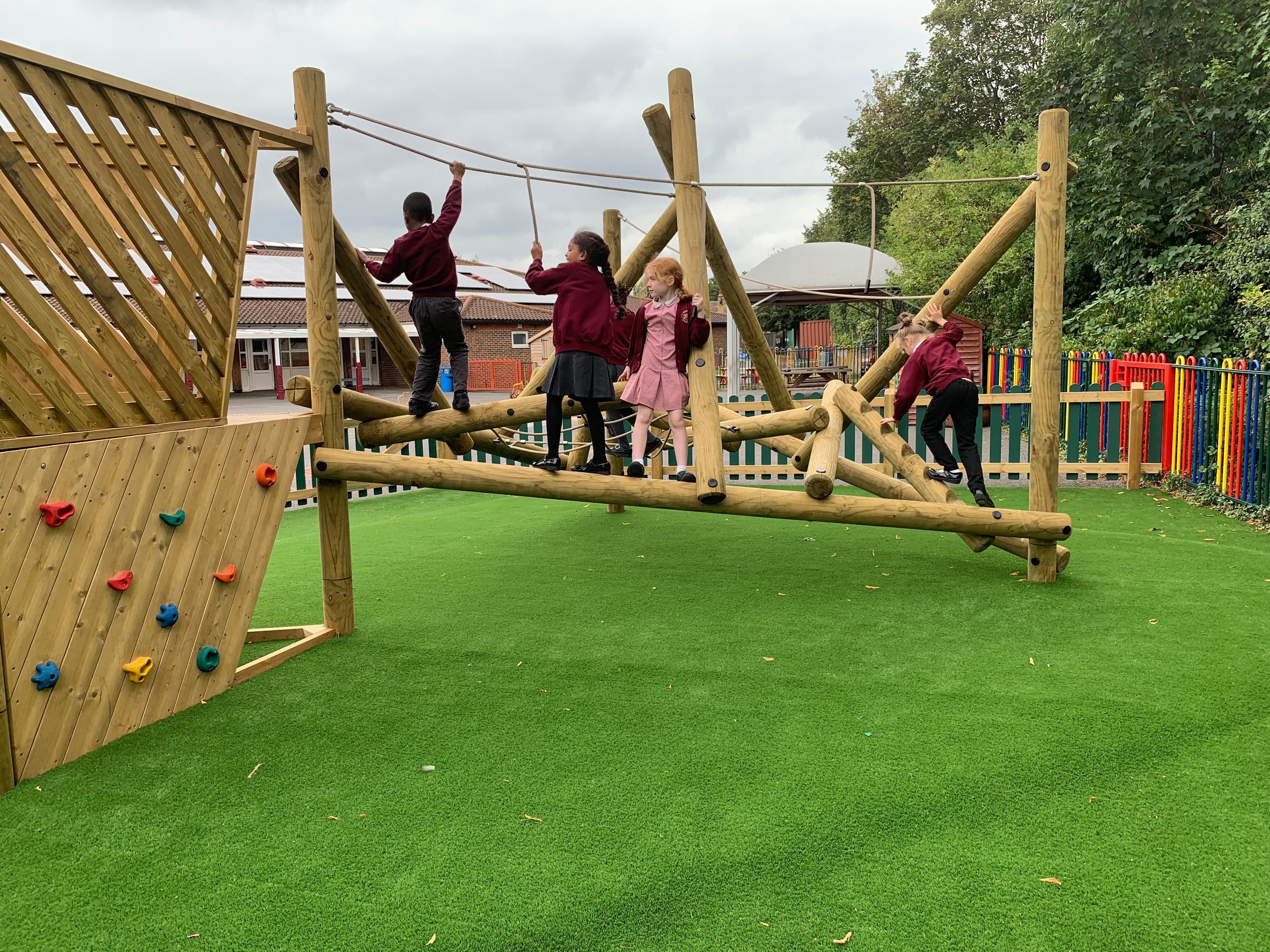 Wooden Bowfell Climbing Frame with Platform and Slide in school playground.