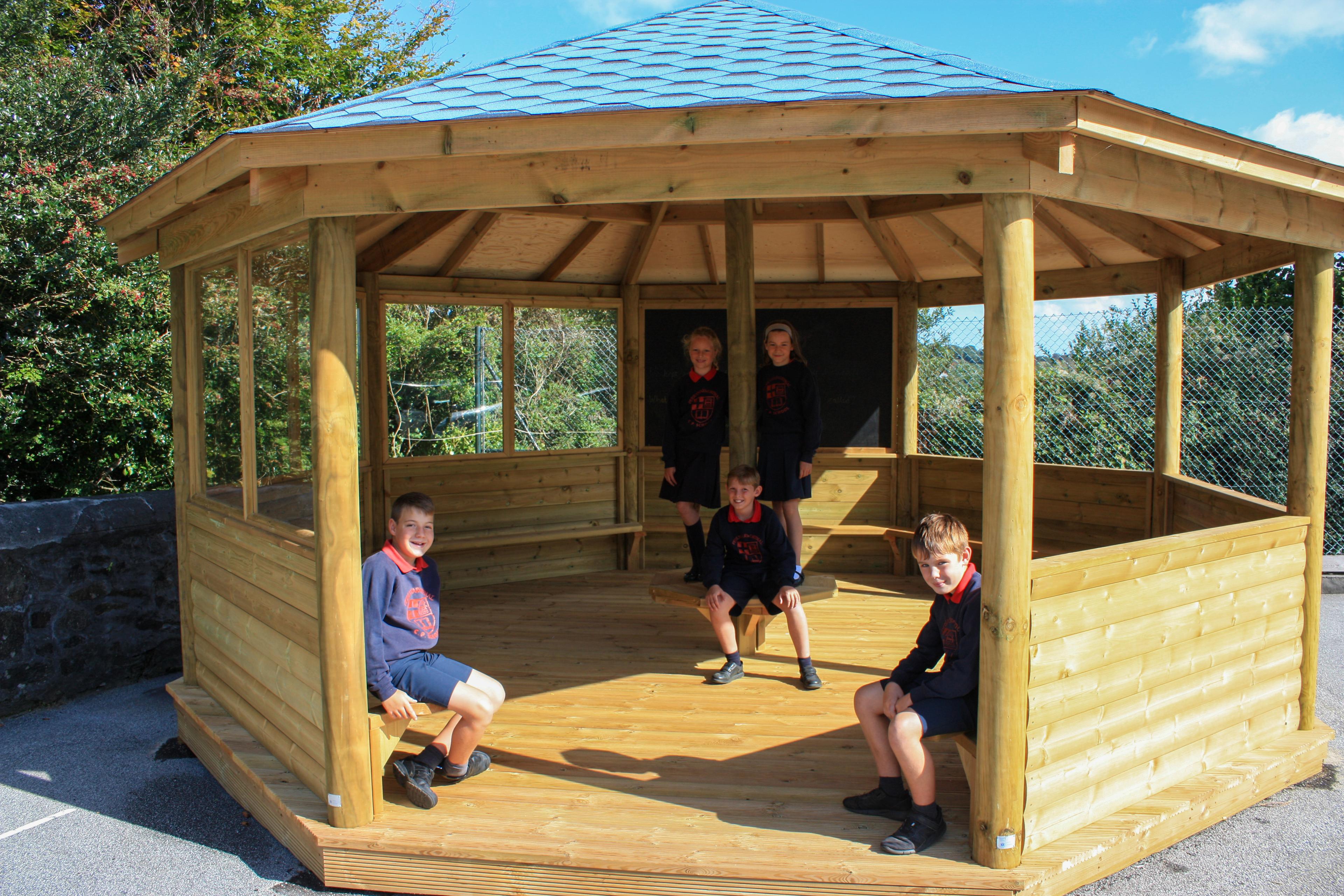 Wooden 6m Octagonal Gazebo with decked base in a school playground.