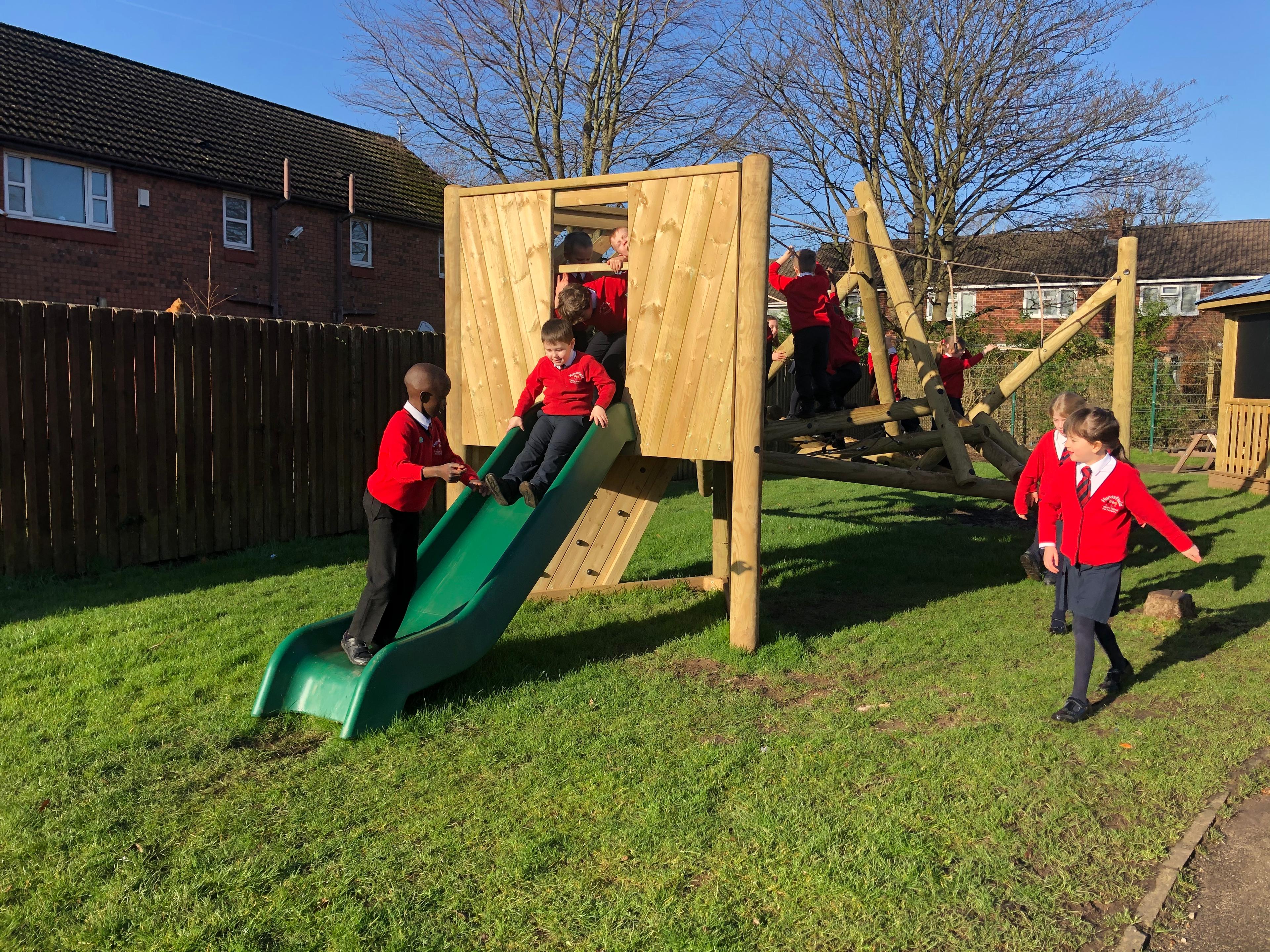 Wooden Bowfell Climbing Frame with Platform and Slide in school playground.