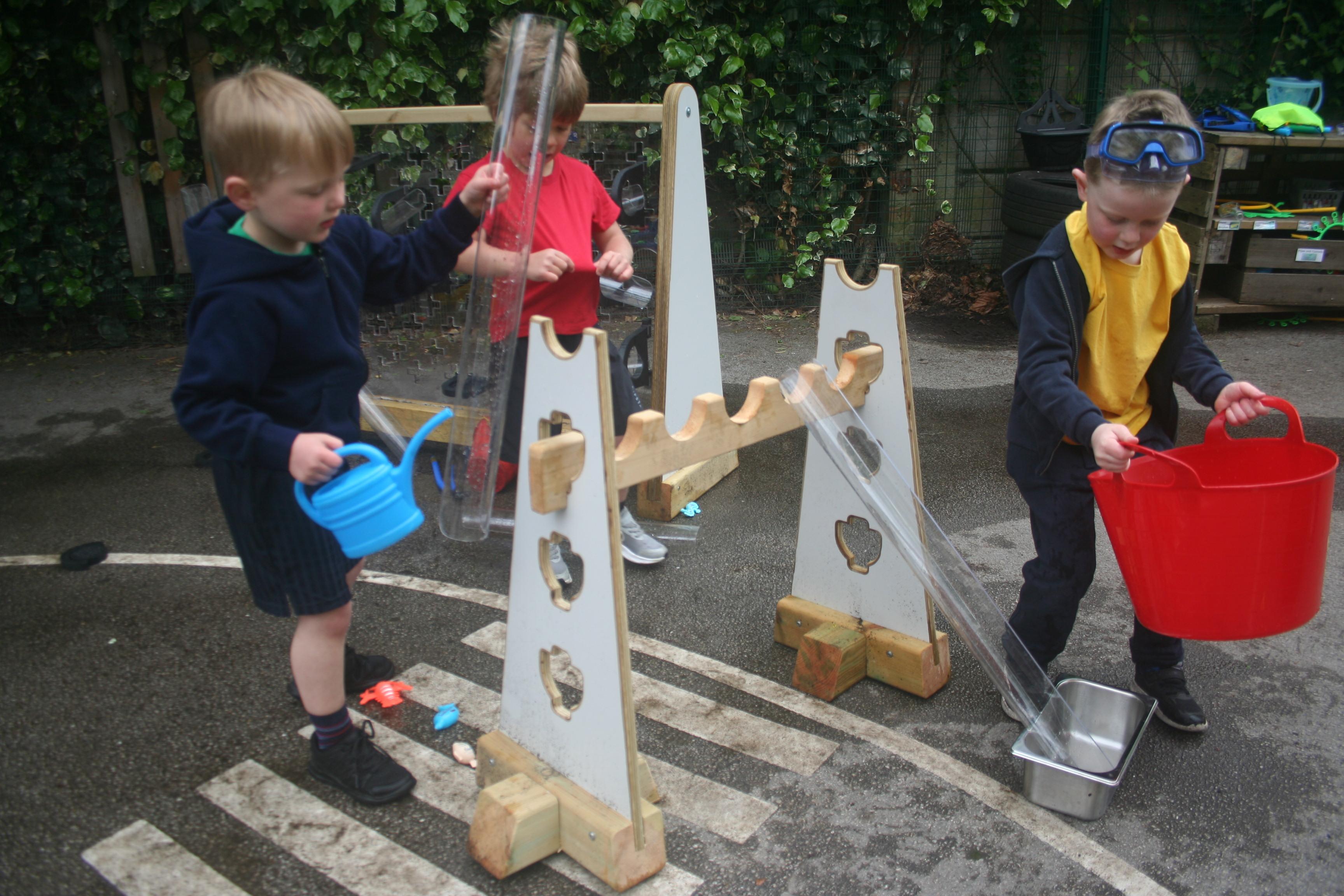 Children playing with water channels that make up part of the Pioneer Messy Play Package