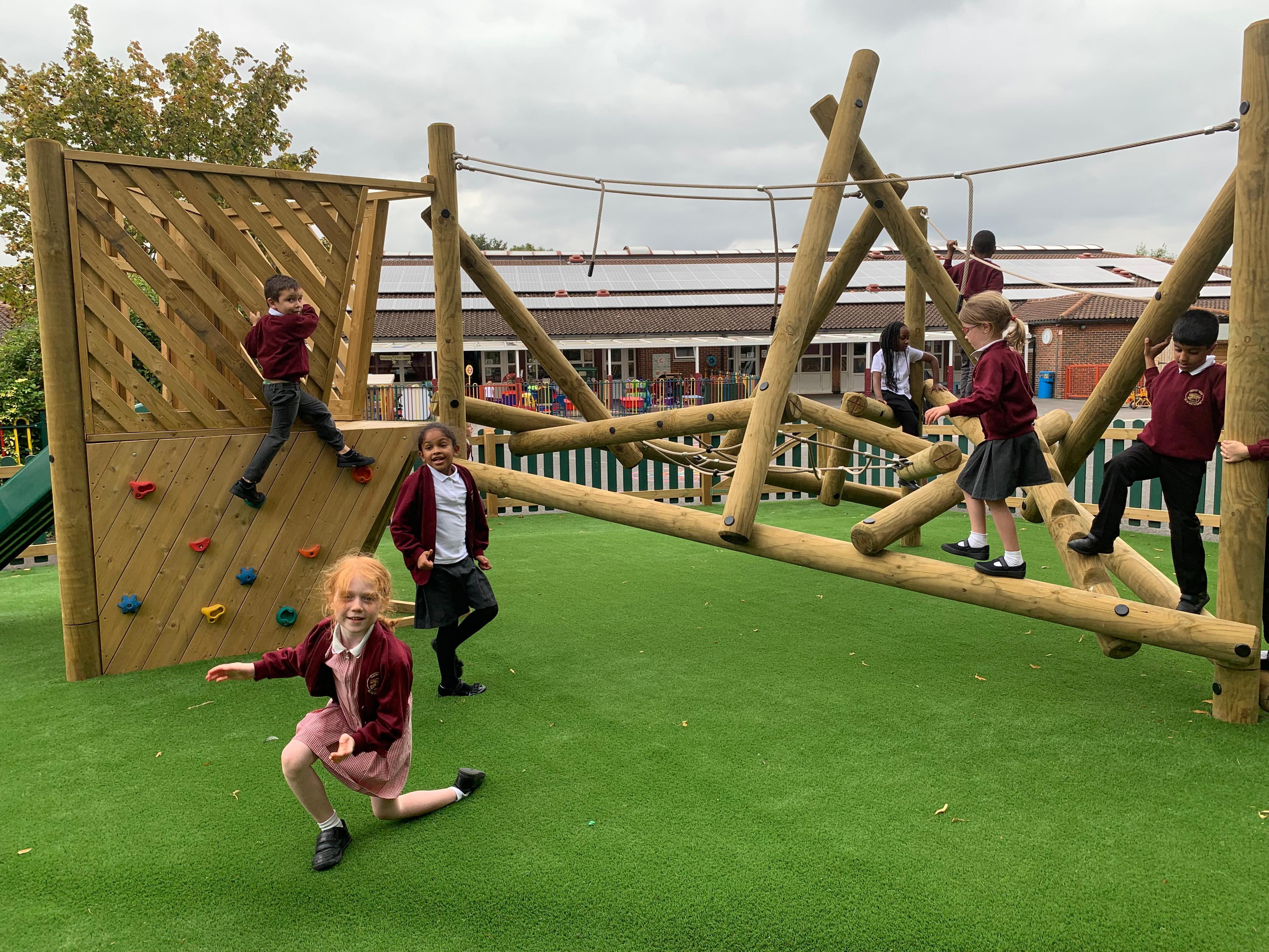 Wooden Bowfell Climbing Frame with Platform and Slide in school playground.