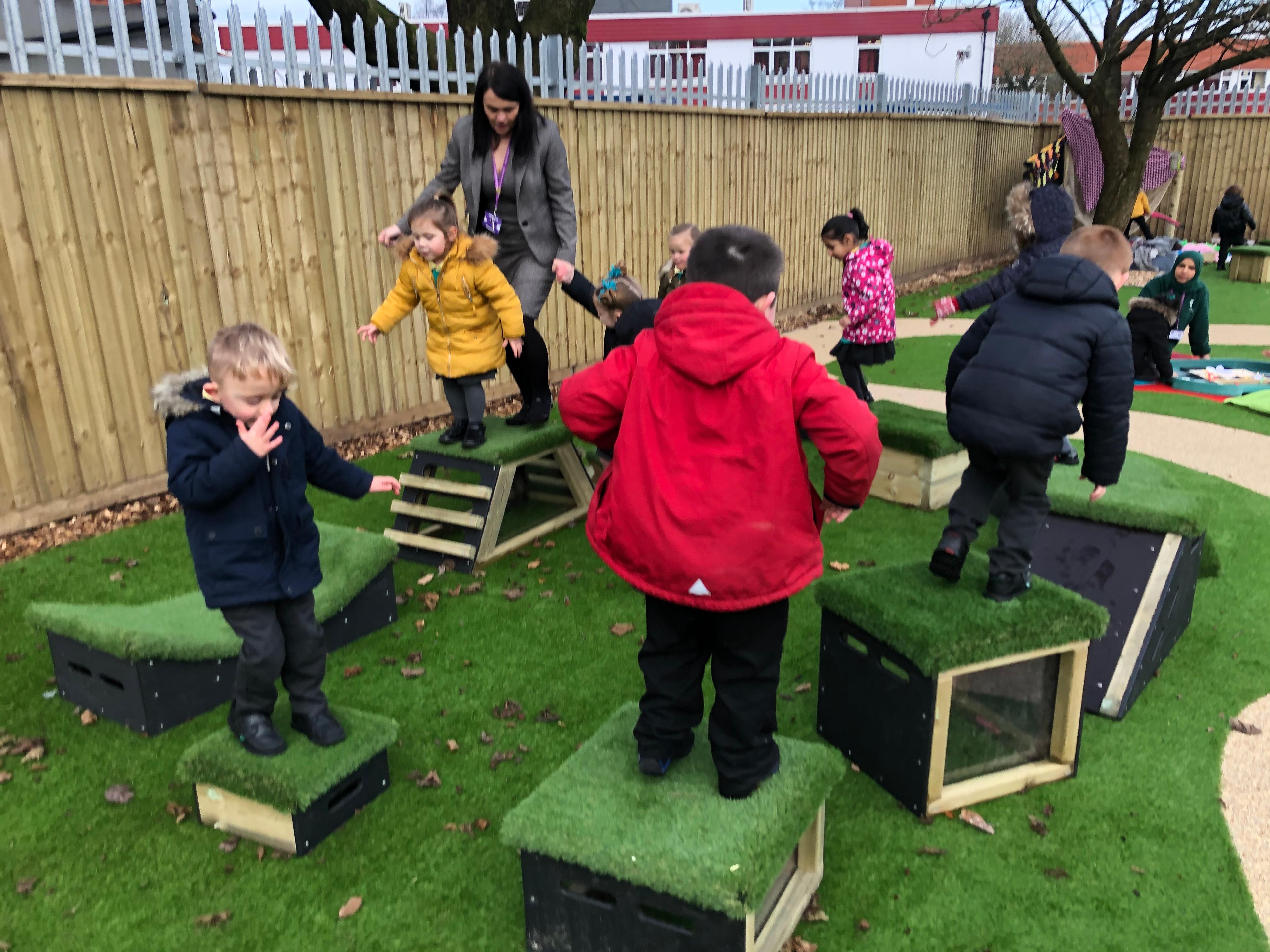 School children playing with grass-topped Get Set, Go! Blocks - The Mendips Set.